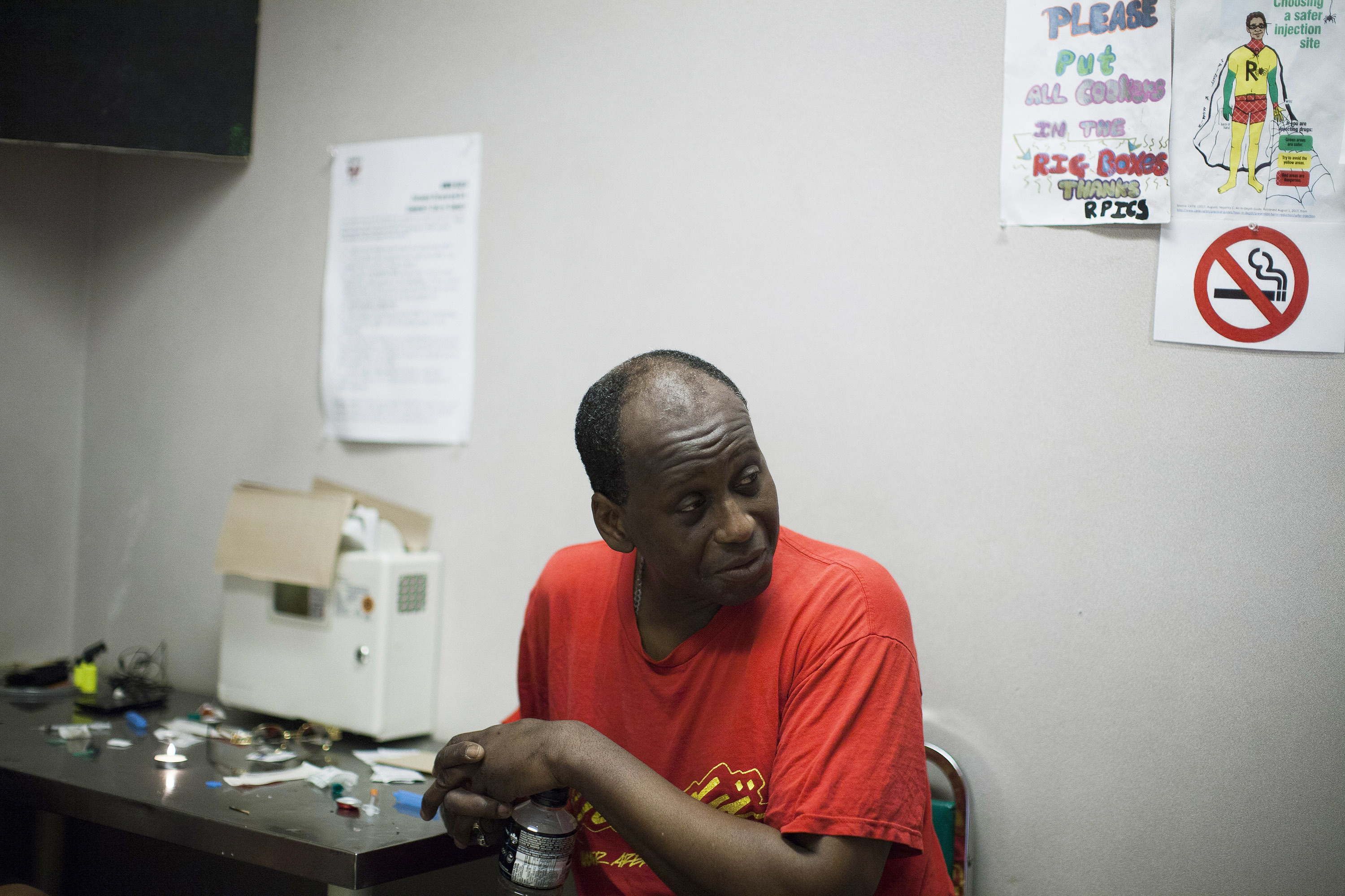 Hugh Lampkin speaks with users inside a supervised injection room in Vancouver, British Columbia. Run by Vancouver Area Network of Drug Users (VANDU), it's a place where peers help each use drugs safely. (Rafal Gerszak for NPR)