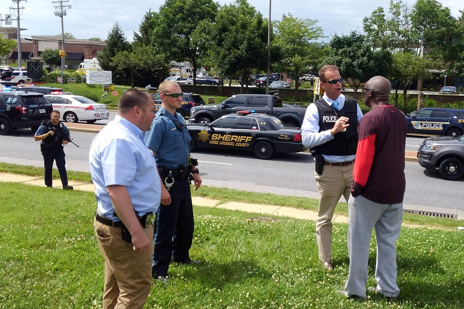 Police officers respond to a shooting at the Capital Gazette newsroom in Annapolis, Md., on Thursday. (Greg Savoy/Reuters)