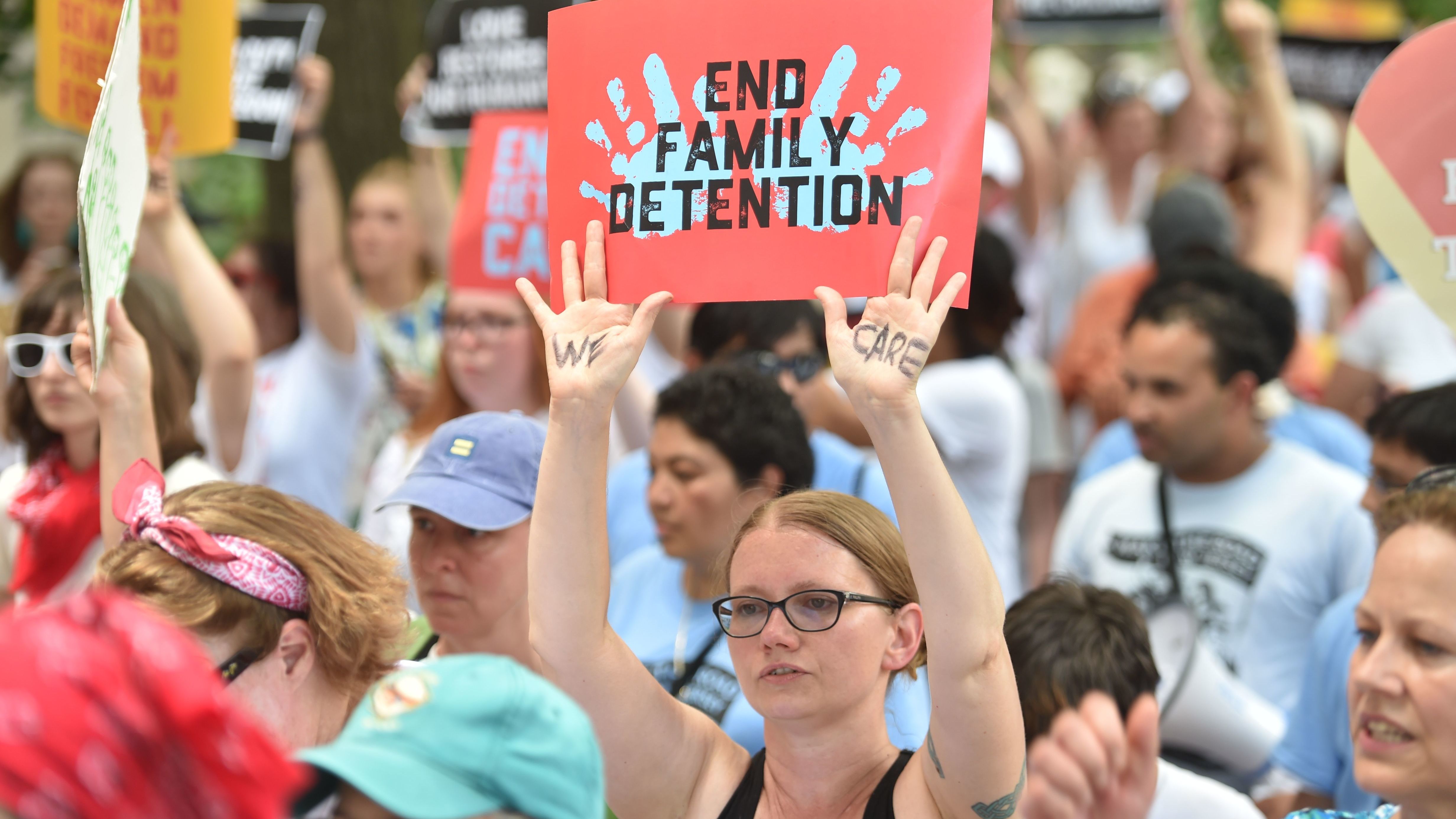 People demonstrate in Washington, D.C., on Thursday, demanding an end to the separation of migrant children from their parents. On Friday, the Justice Department said in a court filing that &quot;the government will not separate families but detain families together during the pendency of immigration proceedings.&quot; (AFP/Getty Images)