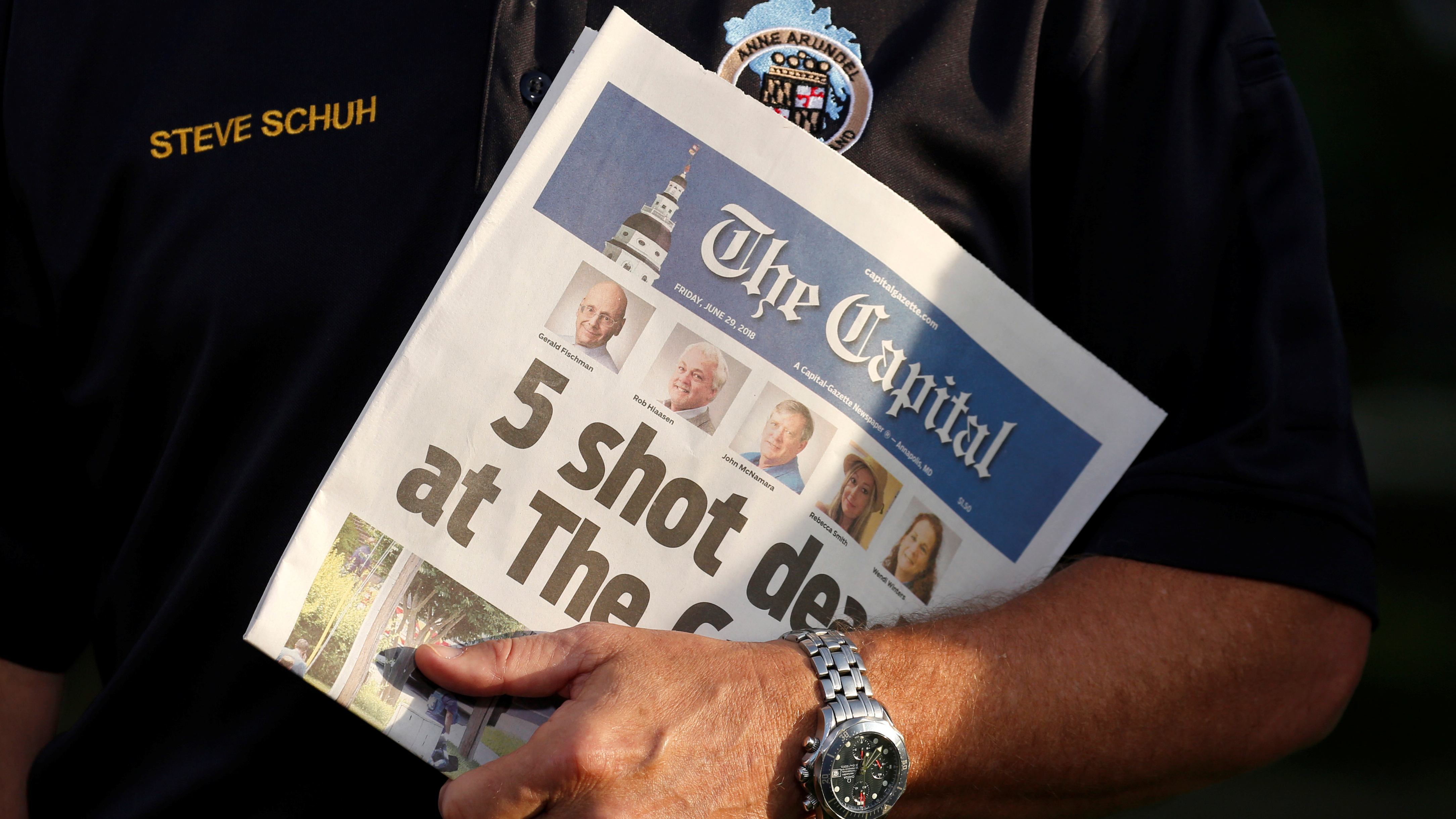 Steve Schuh, county executive of Anne Arundel County, Md., holds a copy of Friday's <em>The Capital</em>. (Reuters)