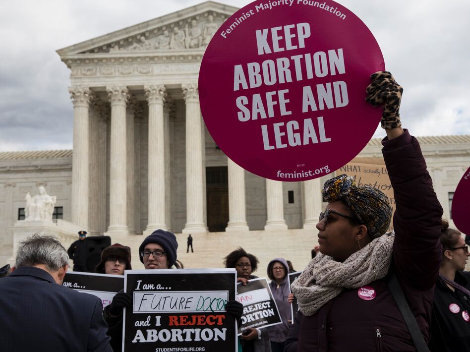 Abortion rights supporters and opponents protest outside the Supreme Court last year. The issue of abortion will spark millions of dollars in spending on advocacy for and against President Trump's Supreme Court nominee. (Zach Gibson/AFP/Getty Images)