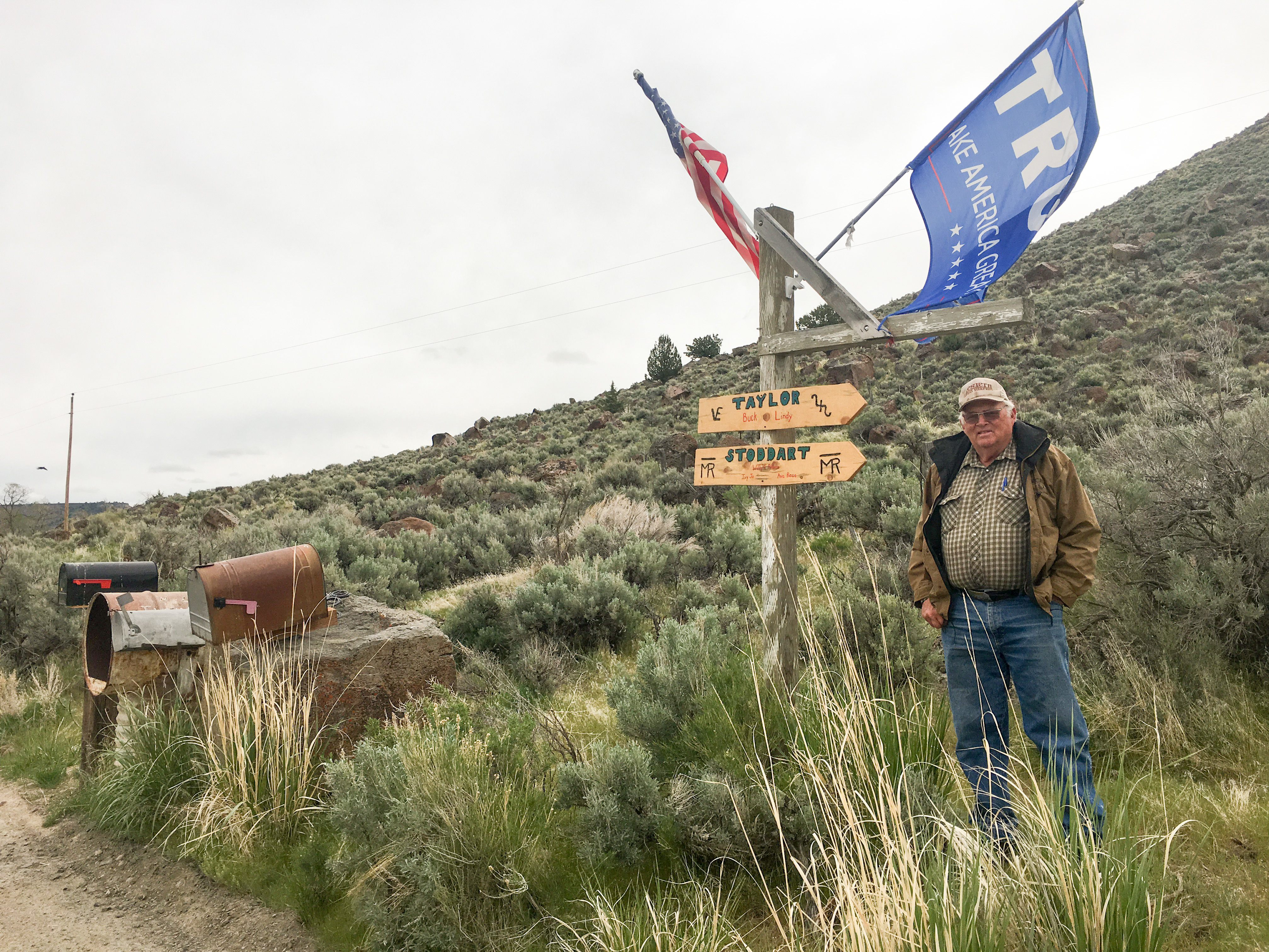 Rancher Buck Taylor proudly flies his American and Trump flags by his driveway mailboxes and signpost in Diamond Valley, Ore. He and other ranchers are facing new tariffs on beef exports that could cost him – but he doesn't blame President Trump. (Northwest News Network)