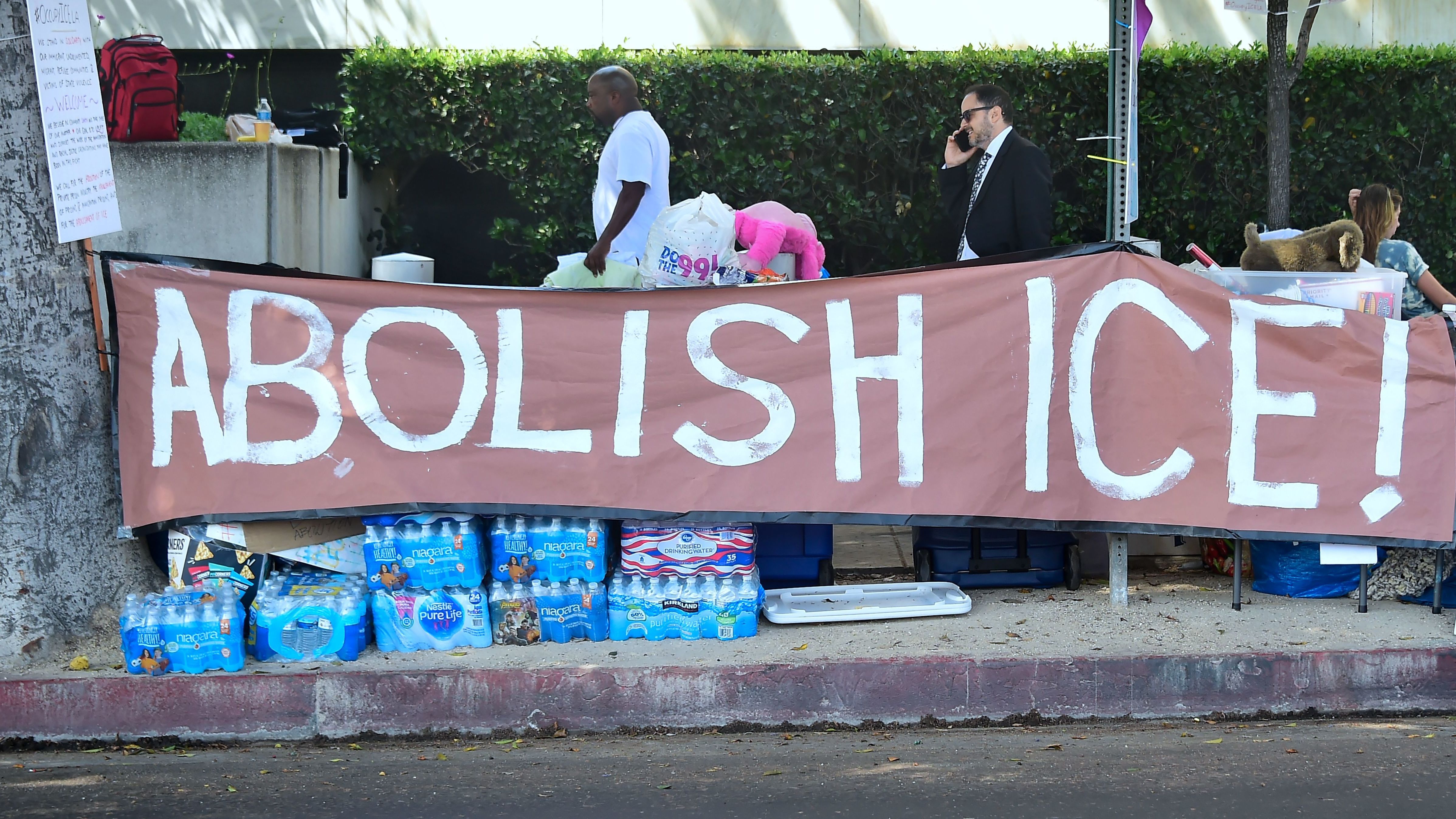 Immigrant rights advocates pitched their tents for an encampment outside the ICE offices in downtown Los Angeles on Thursday. The new liberal rallying cry raises more questions than it answered. (AFP/Getty Images)