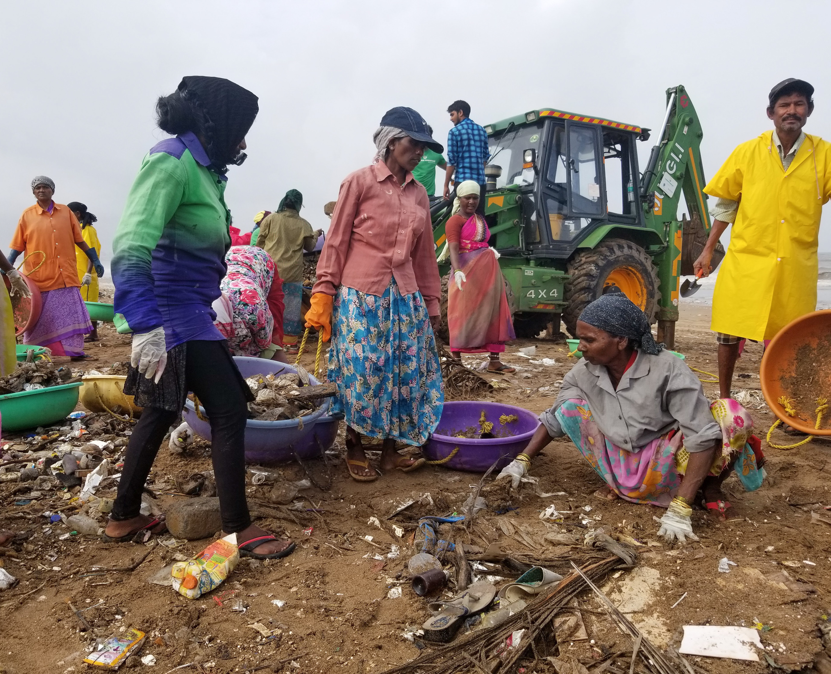 Volunteers and some municipal workers carry buckets of trash to a bulldozer on Mumbai's Versova Beach. Three years ago, a lawyer who lives near the beach, Afroz Shah, started a cleanup campaign on Facebook and Twitter.