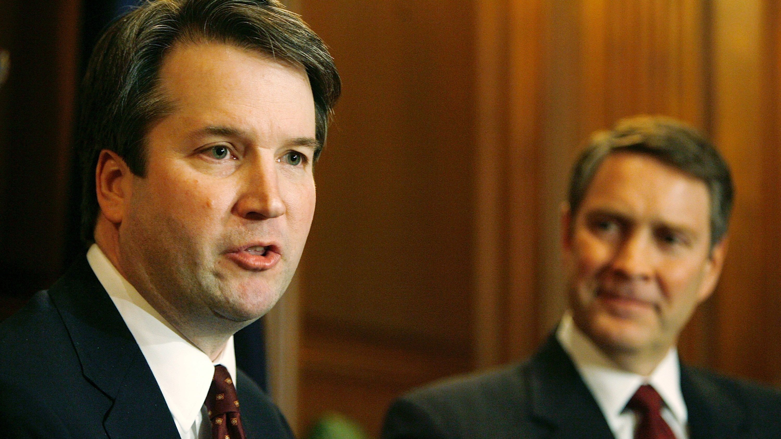 Brett Kavanaugh (left) speaks in 2006, when he was a nominee for the D.C. Circuit Court of Appeals. With him is then-Senate Majority Leader Bill Frist of Tennessee. (Getty Images)