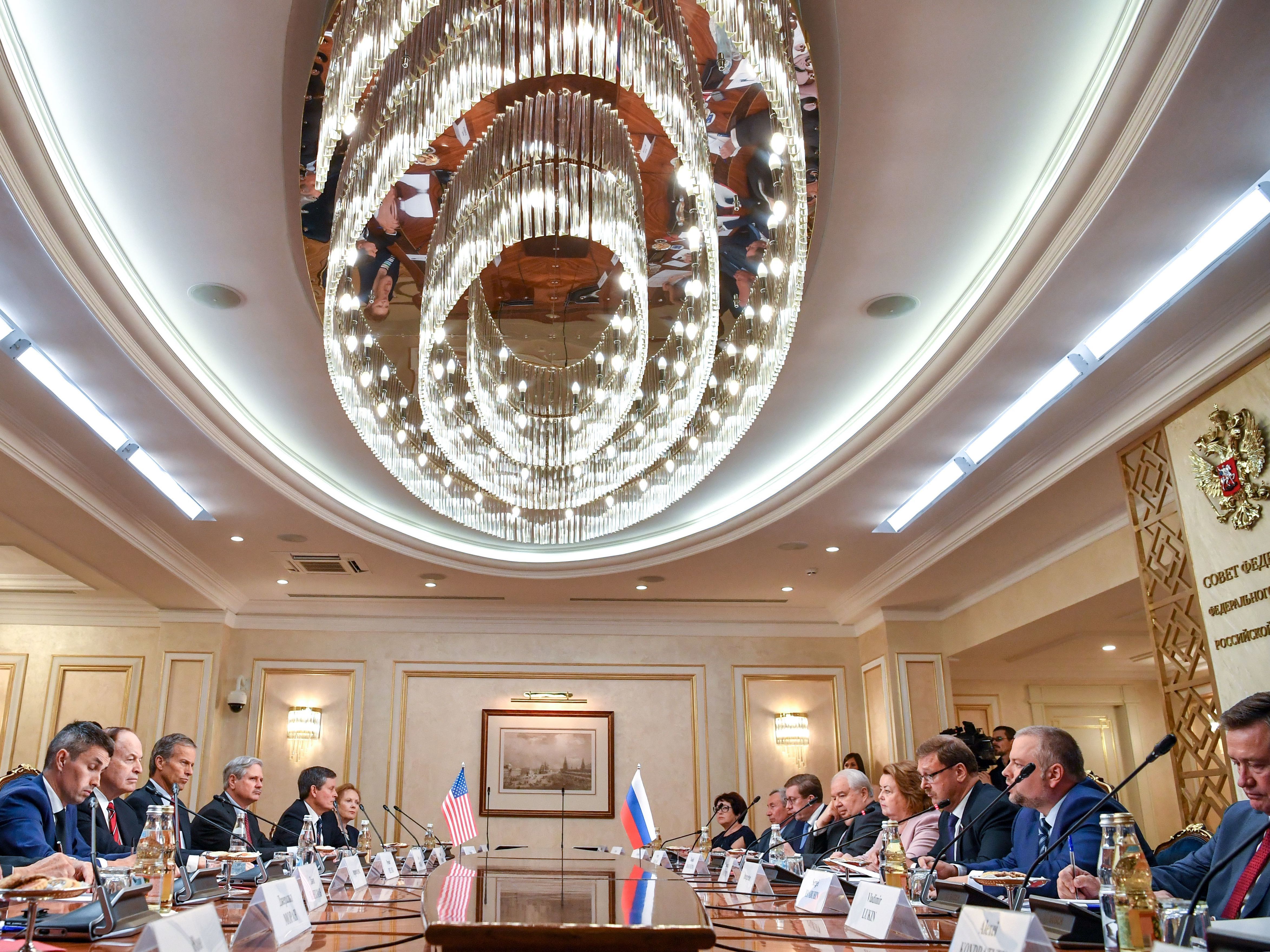 Members of a U.S. congressional delegation meet with members of the Russian Federation Council in Moscow on Tuesday. Republican senators met with Russia's Foreign Minister Sergei Lavrov on a rare visit to Moscow ahead of a summit between the countries' presidents Vladimir Putin and Donald Trump. (AFP/Getty Images)