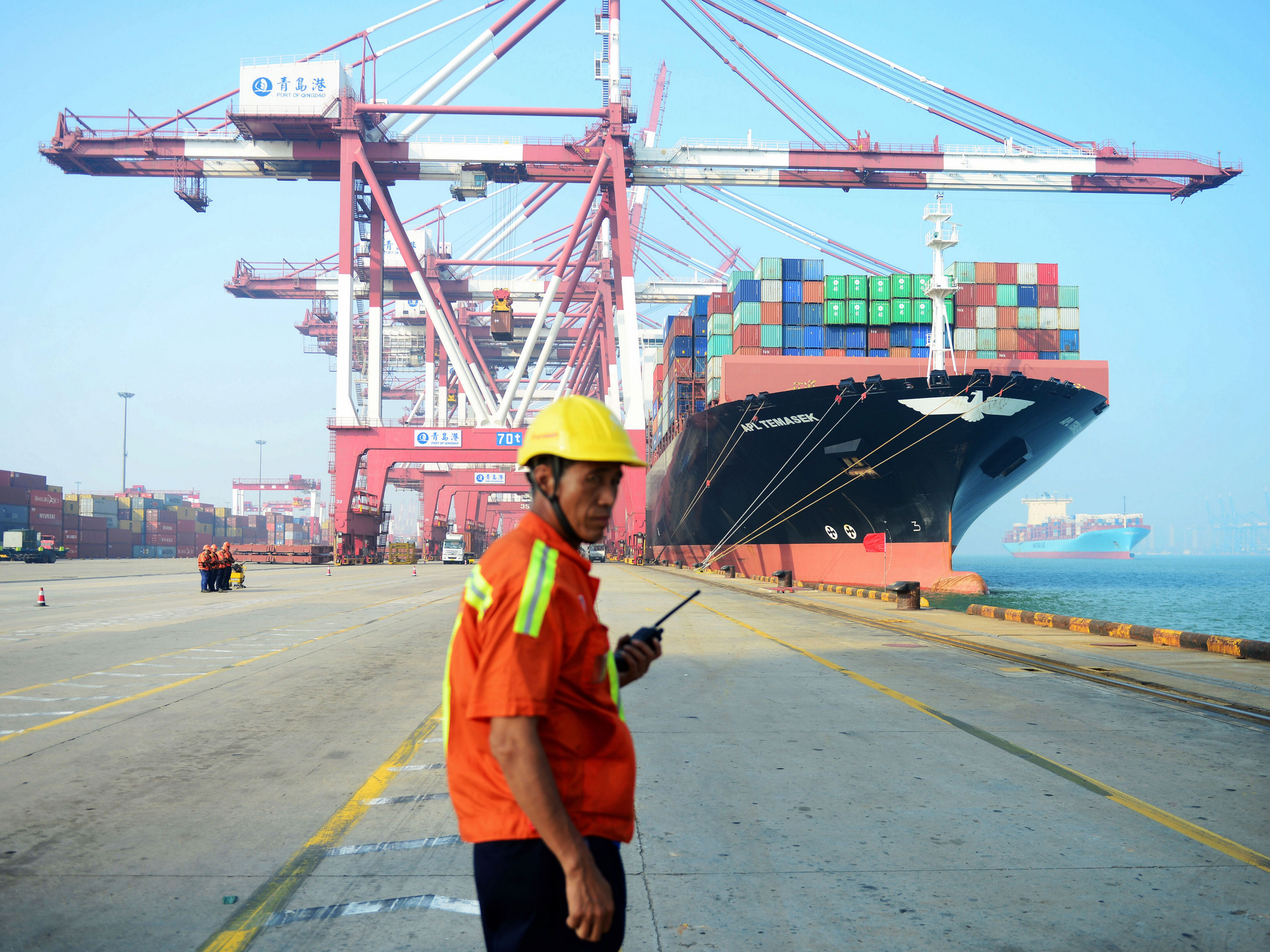 A Chinese worker looks on as a cargo ship is loaded at a port in Qingdao, in eastern China's Shandong province, in July 2017. The United States is China's biggest single export market. (AFP/Getty Images)