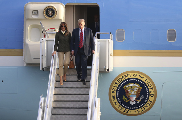 U.S. President Donald Trump and first lady Melania Trump disembark from Air Force One as they arrived in  Scotland on Friday.