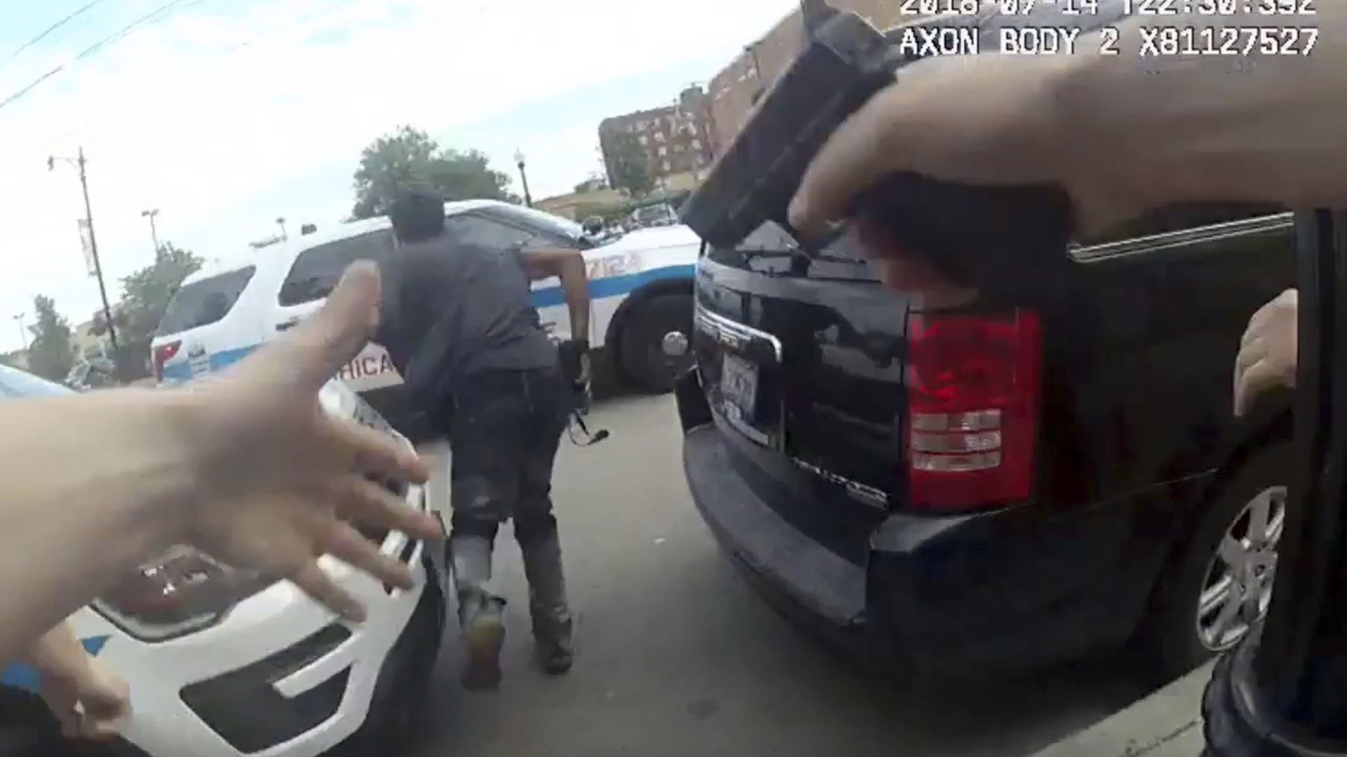 This frame grab from police body cam video provided by the Chicago Police Department shows authorities trying to apprehend a suspect, center, who appeared to be armed, Saturday in Chicago. The suspect was fatally shot by police during the confrontation.