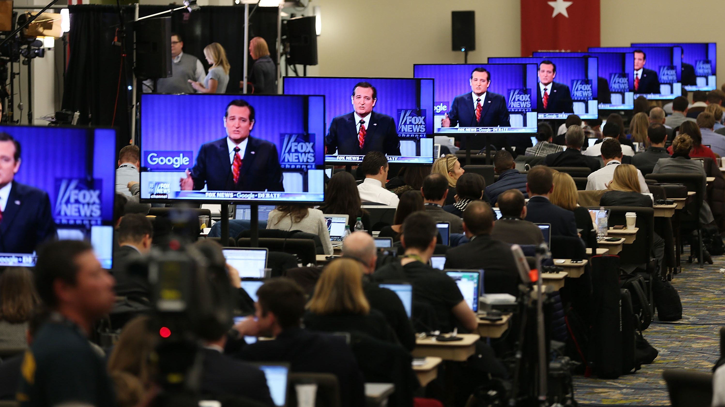 Television screens are tuned to a Republican presidential debate sponsored by Fox News and Google in January 2016. &quot;People who get their news from Fox News actually take the strongest anti-immigrant position of any group we looked at in this survey,&quot; one pollster says. (Getty Images)