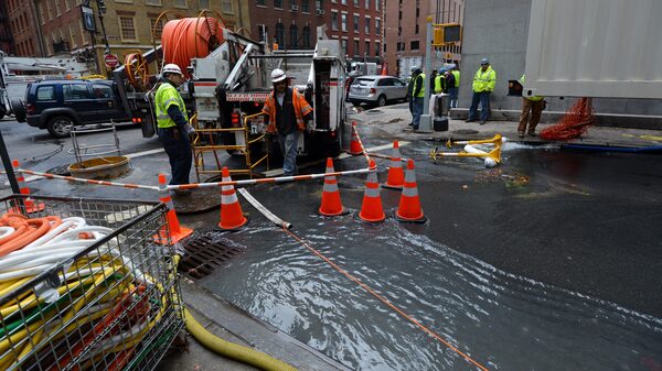 Verizon crews pump water from an access tunnel in Manhattan in 2012 after flooding from Superstorm Sandy knocked out underground Internet cables.