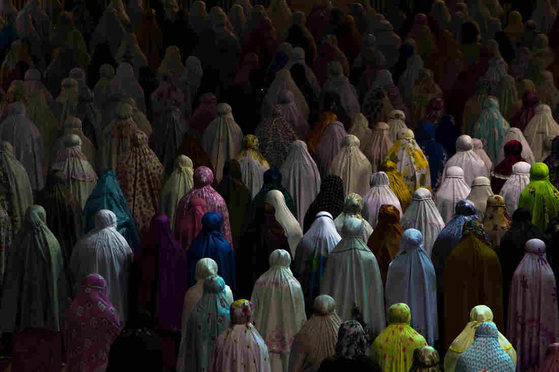 Muslim women praying together in Istiqlal mosque, Jakarta, Indonesia.