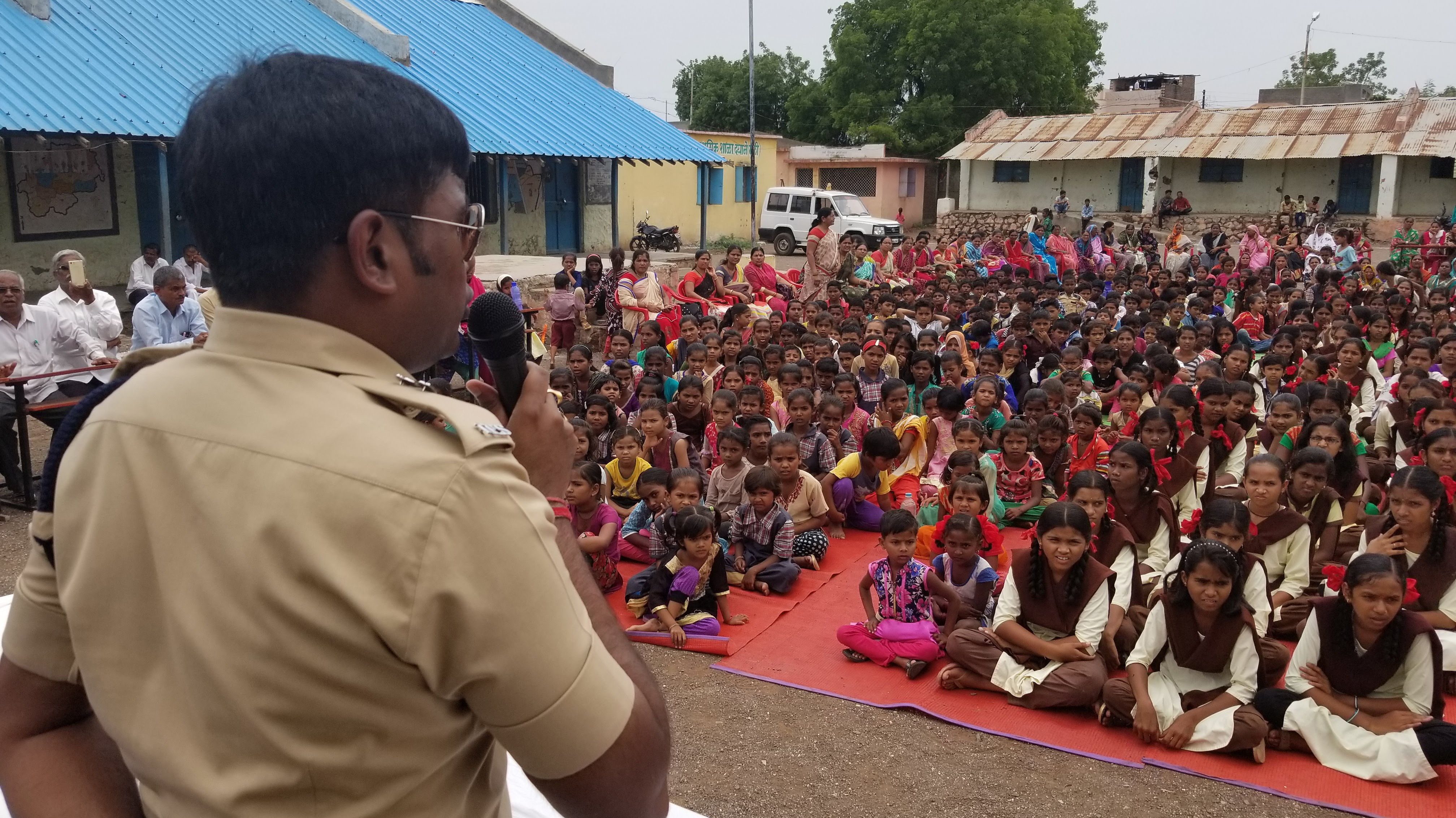 Harssh Poddar, a senior police official, addresses a village meeting at a rural school near Malegaon, in northern Maharashtra state. He warns families to be skeptical of what they read online. Earlier this month, Poddar helped rescue five people from being killed by a mob in his constituency. (Lauren Frayer/NPR)