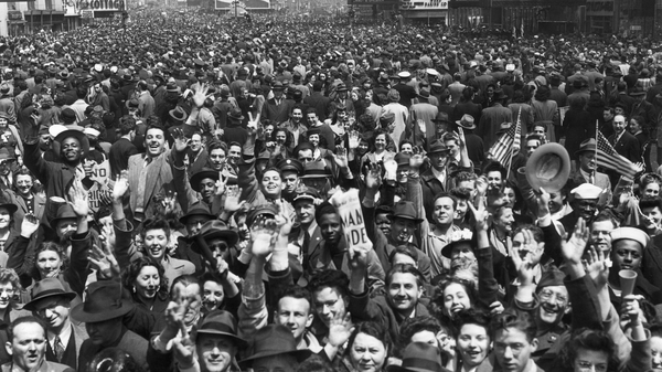 An enormous New York crowd celebrates VE Day at the end of WWII. Aaron Copland was inspired to write his "Fanfare for the Common Man" by a wartime speech rallying Americans against imperialism.