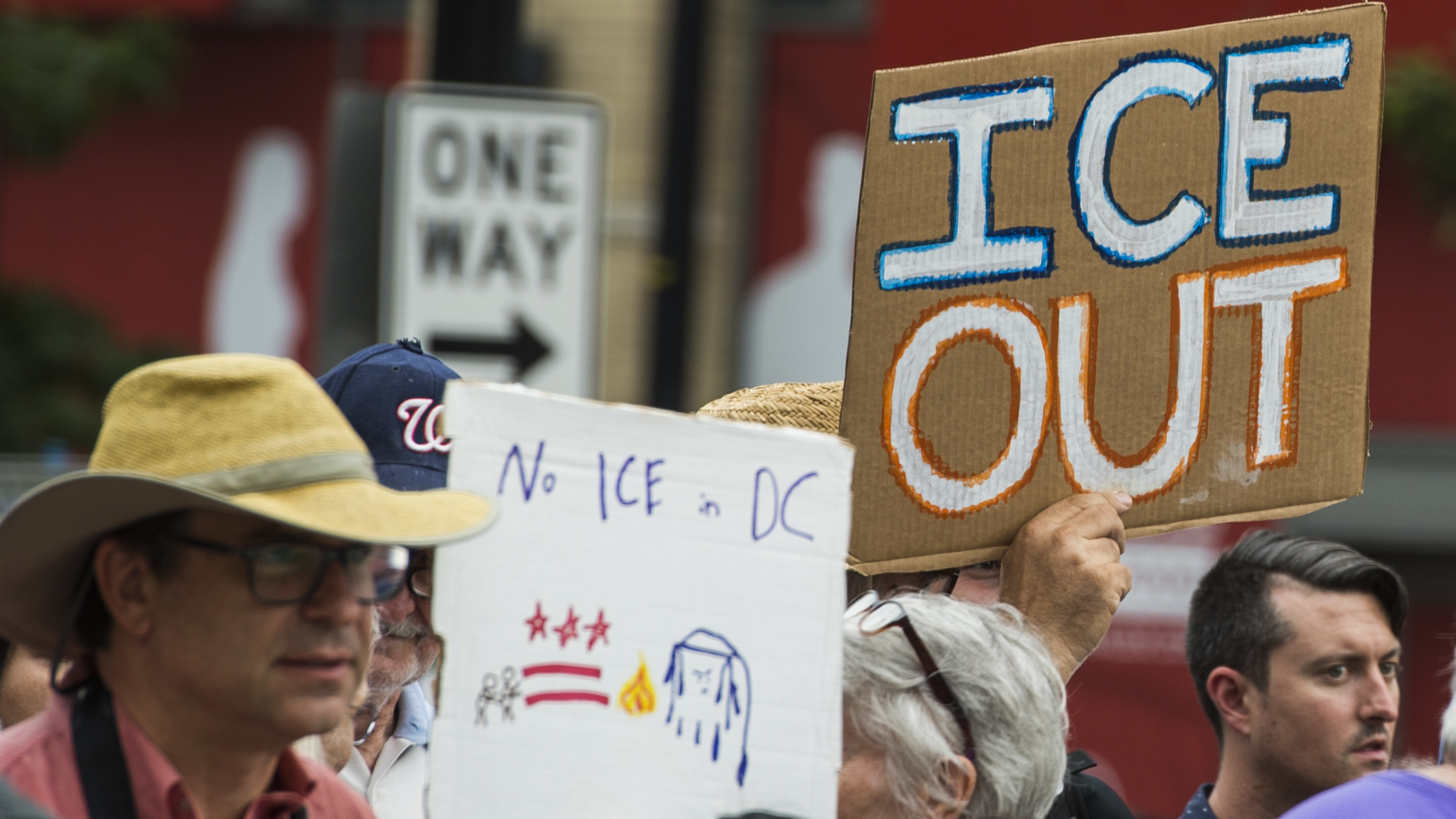 People hold up signs July 16 in Washington, D.C., as they protest ICE. Getting rid of the agency has become a popular rallying cry among progressives, but the House on Wednesday overwhelmingly passed a symbolic measure voicing support for ICE. (AFP/Getty Images)