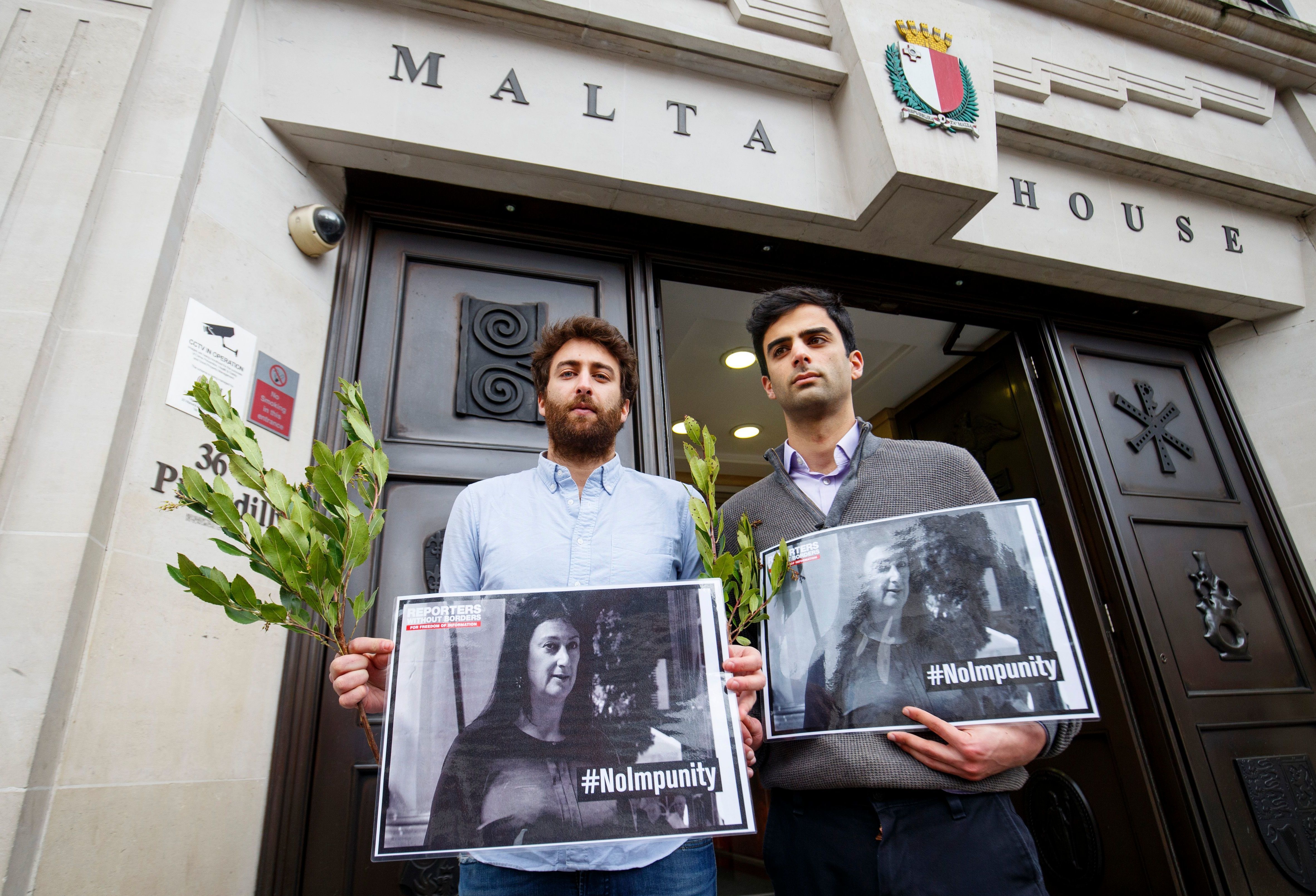Matthew Caruana Galizia (left) and Paul Caruana Galizia, the sons of murdered Maltese journalist Daphne Caruana Galizia, attend a vigil outside the Maltese High Commission in London on April 16, six months after she was assassinated. (AFP/Getty Images)