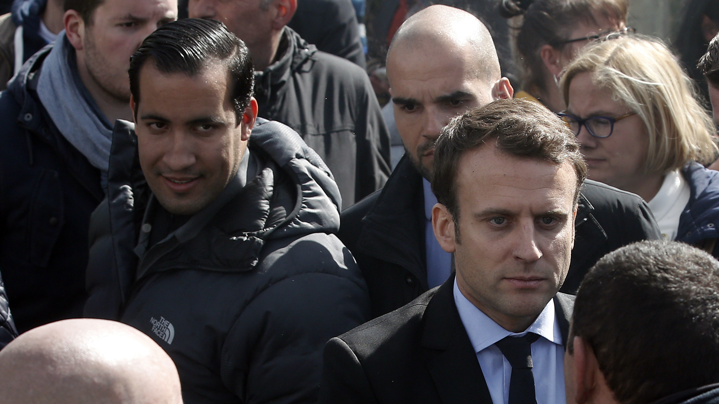 Emmanuel Macron (right) is flanked by his bodyguard, Alexandre Benalla (left) in Amiens, France. Benalla was filmed in May beating protesters during labor demonstrations.