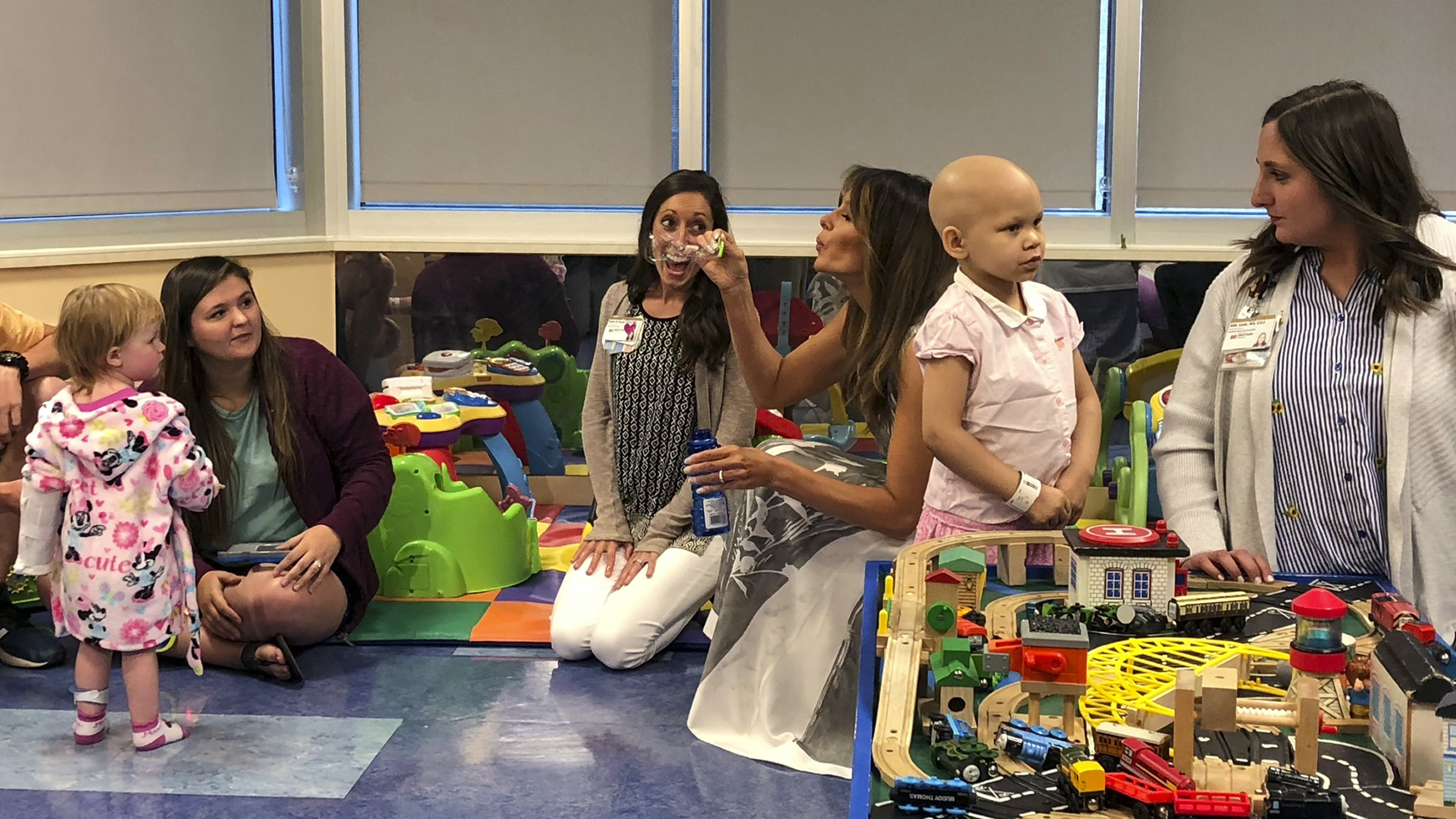 Melania Trump blows bubbles in a playroom with children during a visit to Monroe Carell Jr. Children