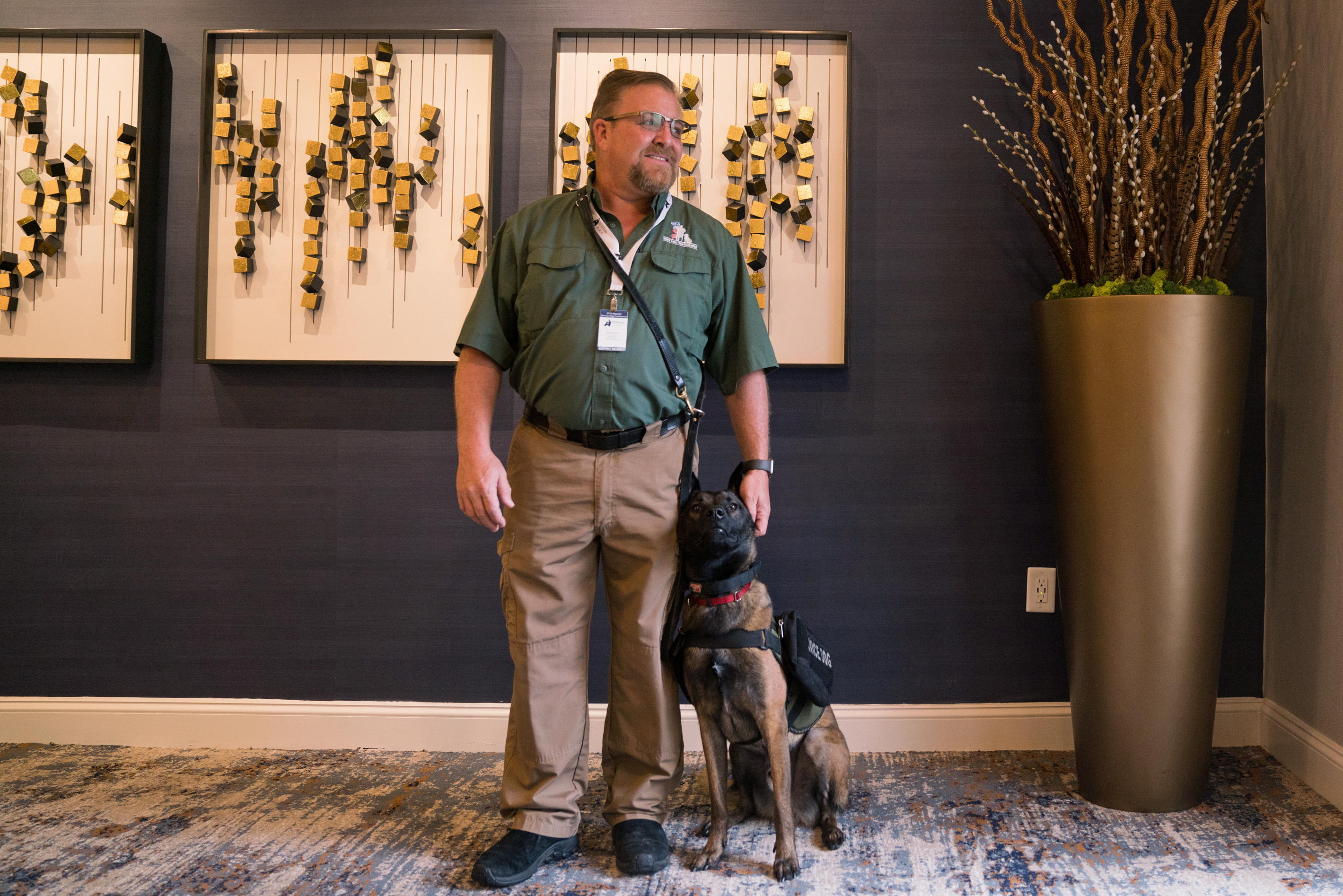 Brett Simon, president and co-founder of K9s for Warriors organization, stands with his dog Lincoln at the Association of Service Dog Providers for Military Veterans annual conference in Tyson's Corner, Va. The nonprofit bills itself as the largest provider of psychiatric service dogs for veterans. (NPR)