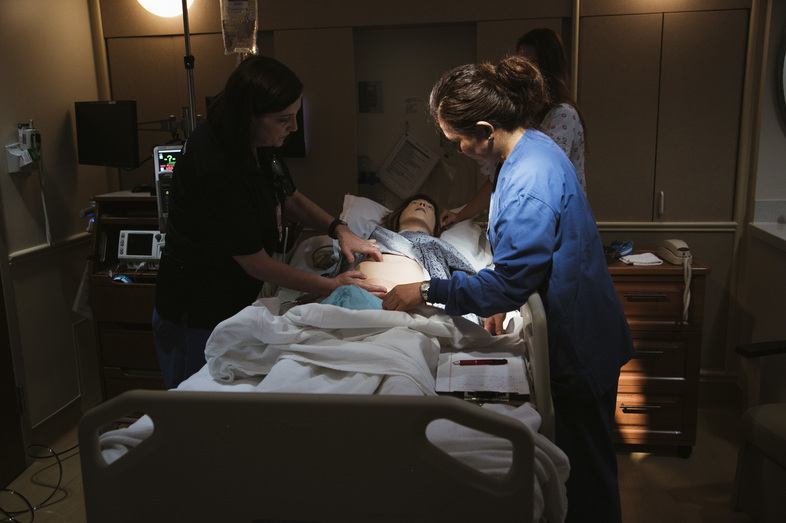 Using a mannequin to simulate dangerous scenarios, a team at Pomona Valley Hospital Medical Center learns standard treatments for obstetric emergencies like hemorrhage. (Bethany Mollenkof for NPR)