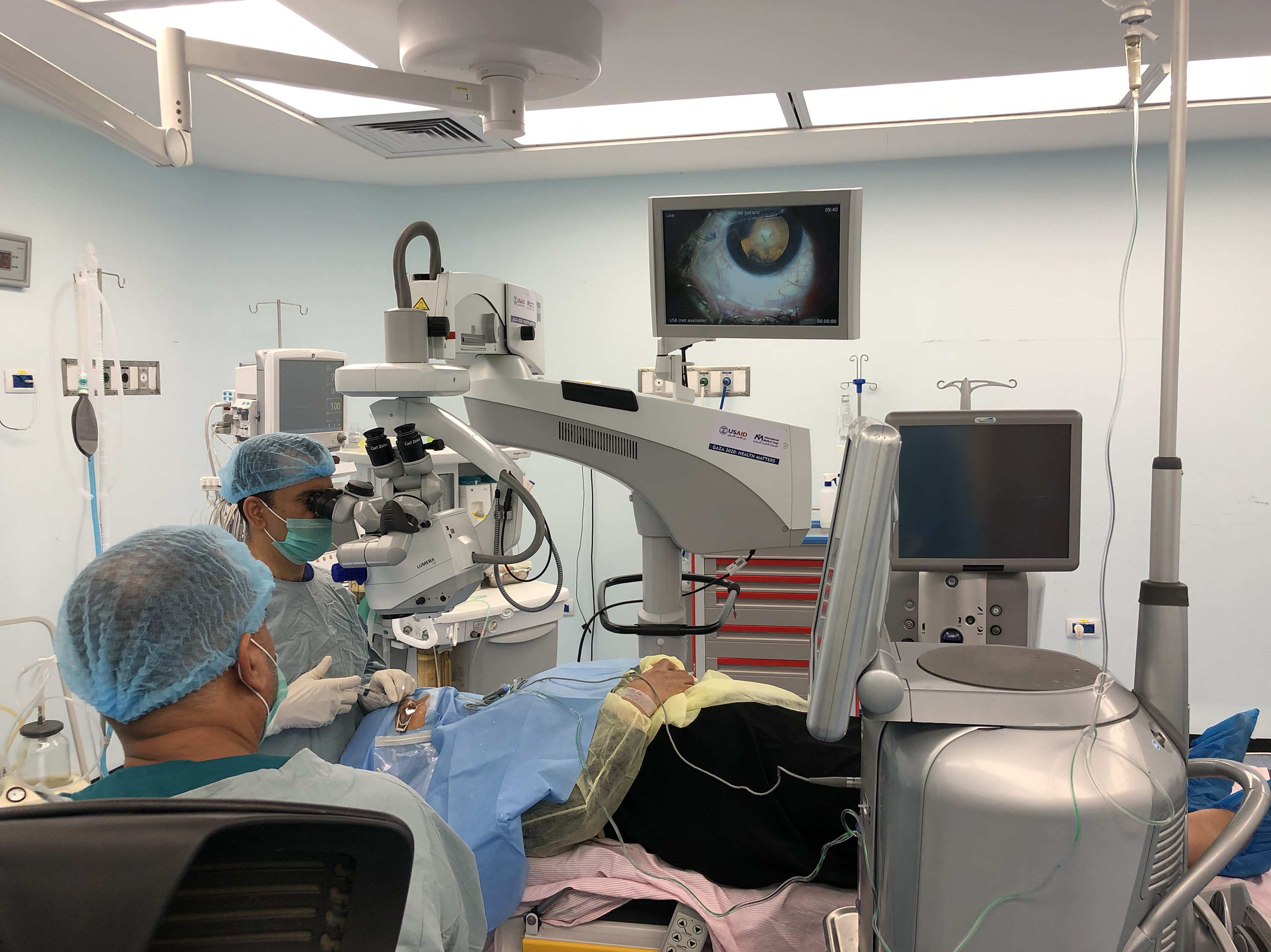 At St. John Eye Hospital in Gaza, a Palestinian surgeon removes a woman's cataract using surgery equipment branded with a sticker that says, in Arabic, &quot;From The American People.&quot; U.S. funding subsidizes these surgeries for Palestinians who could not otherwise afford them, but funding cuts means subsidies will not continue, hospital administrators say. (Daniel Estrin/NPR)
