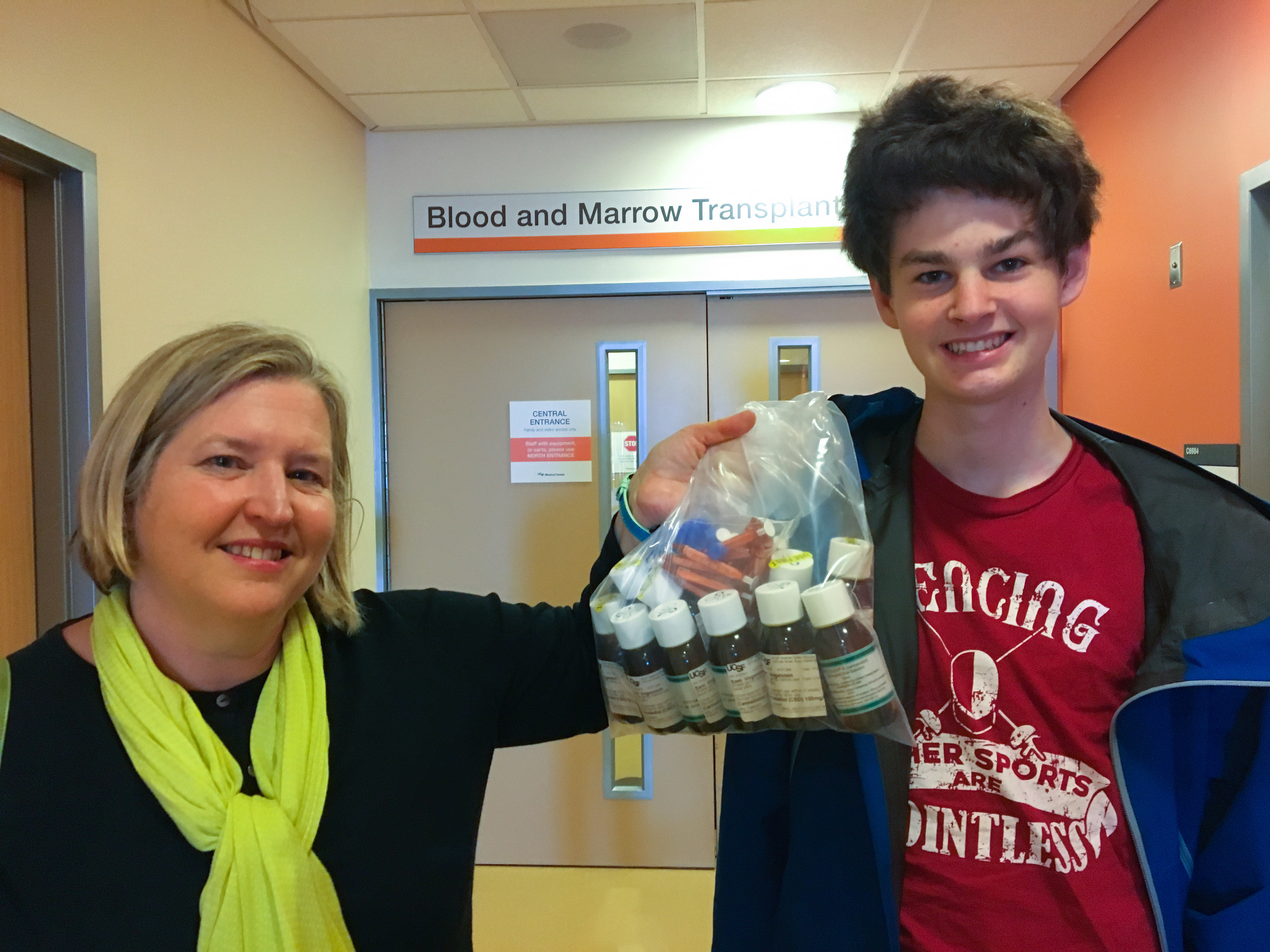Evelyn Nussembaum and her son Sam Vogelstein pick up a six month supply of Epidiolex from the experimental pharmacy at UCSF. (Lesley McClurg/KQED)
