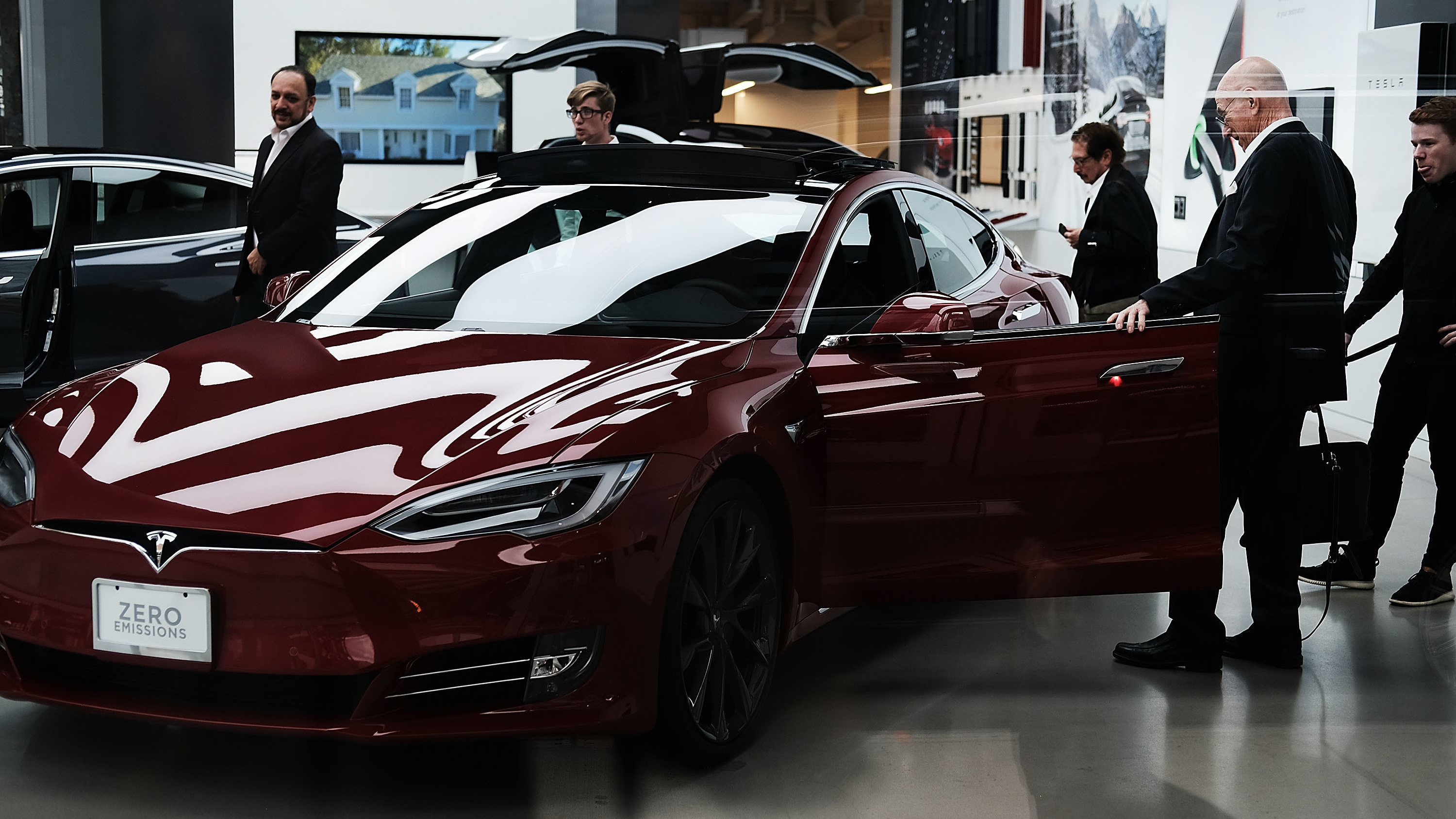 People look at cars at a Tesla showroom in New York City. Tesla CEO Elon Musk, reportedly under scrutiny by federal regulators for earlier statements, says Saudi Arabia