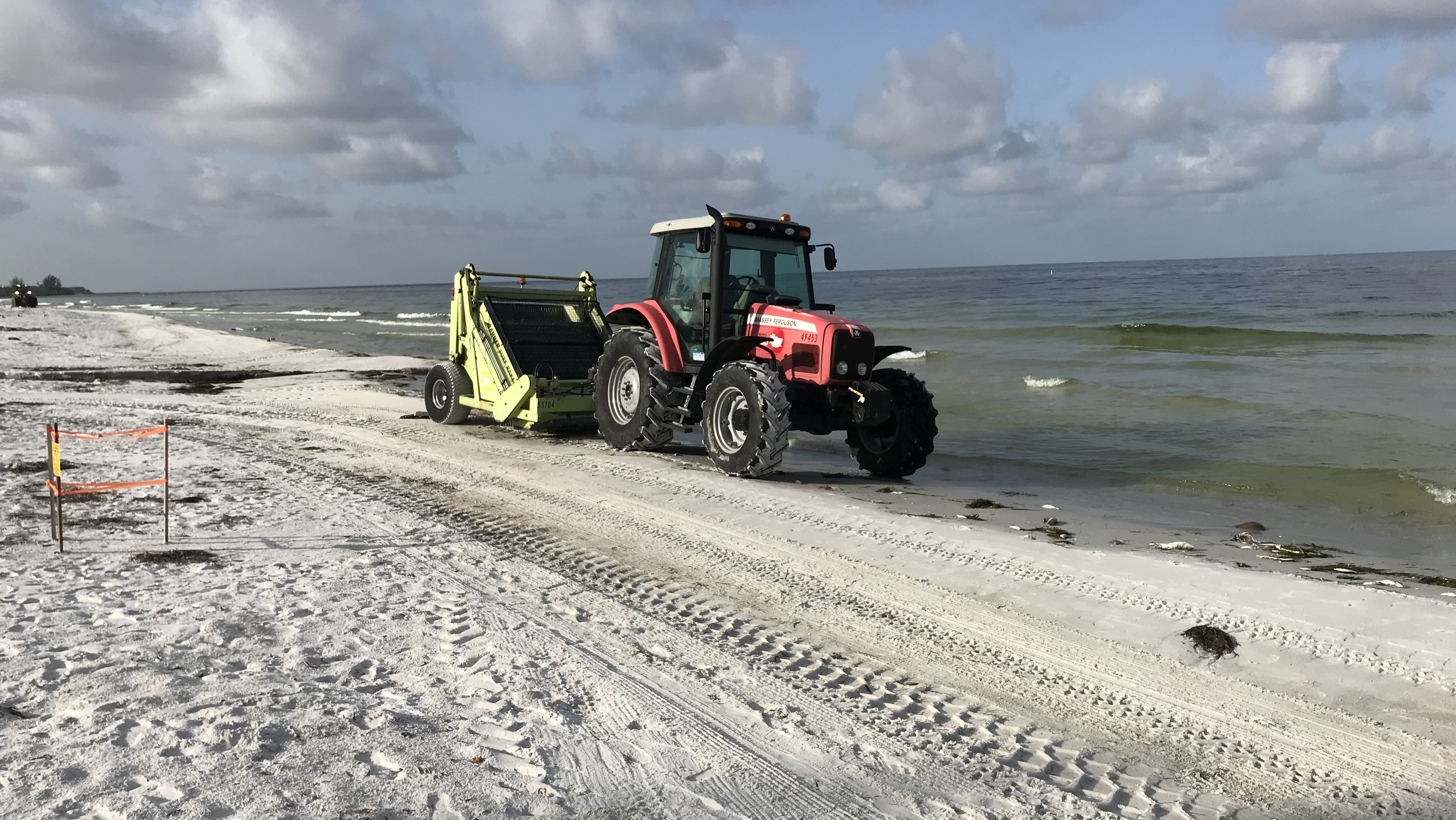 At Coquina Beach, crews are out early using beach rakes to clear dead fish. The fish are dying because of a toxic algae bloom known as red tide. (NPR)