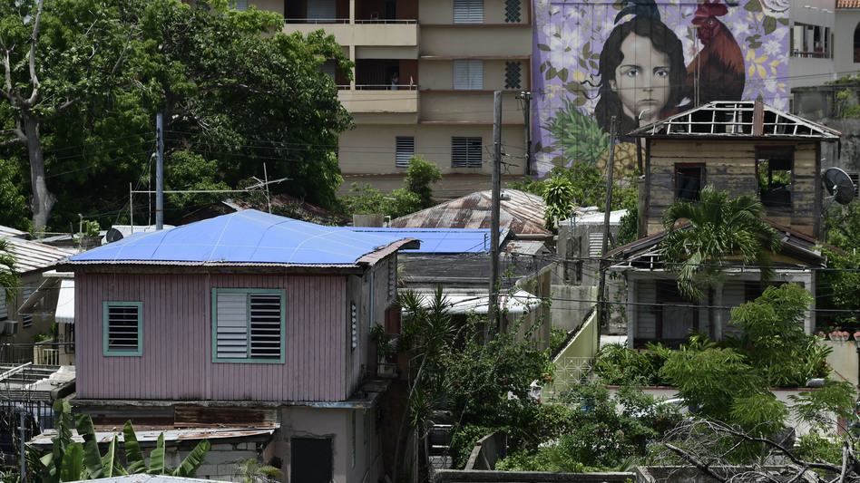 Some houses affected by Hurricane Maria remained covered in tarps or missing roofs as recently as June in San Juan, Puerto Rico's El Gandul neighborhood. (Carlos Giusti/AP)