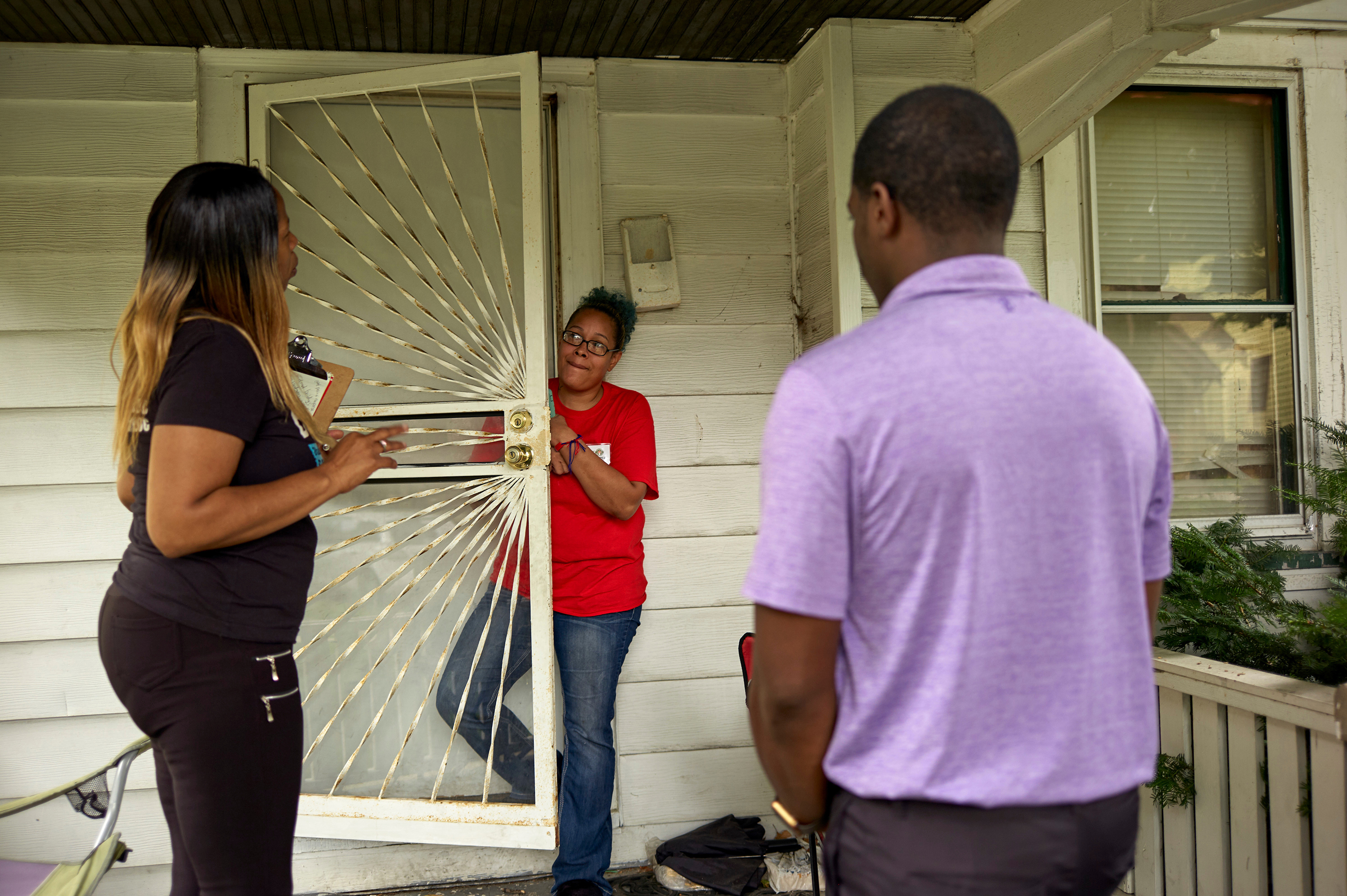 Wisconsin State Rep. David Crowley, right, works with Keisha Robinson, left, of BLOC, Black Leaders Organizing for Communities as he takes part in a silent canvass where Mr. Crowley is only allowed to listen to community members like Quiana Jasper, center, Aug. 7, 2018 Milwaukee.
