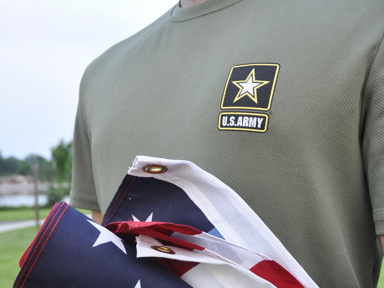 In this Tuesday, July 3, 2018, photo, a Pakistani recruit, 22, who was recently discharged from the U.S. Army, holds an American flag as he poses for a picture. The Army said in court documents it has reinstated more than 30 immigrant recruits and reservists whose contracts had been terminated.