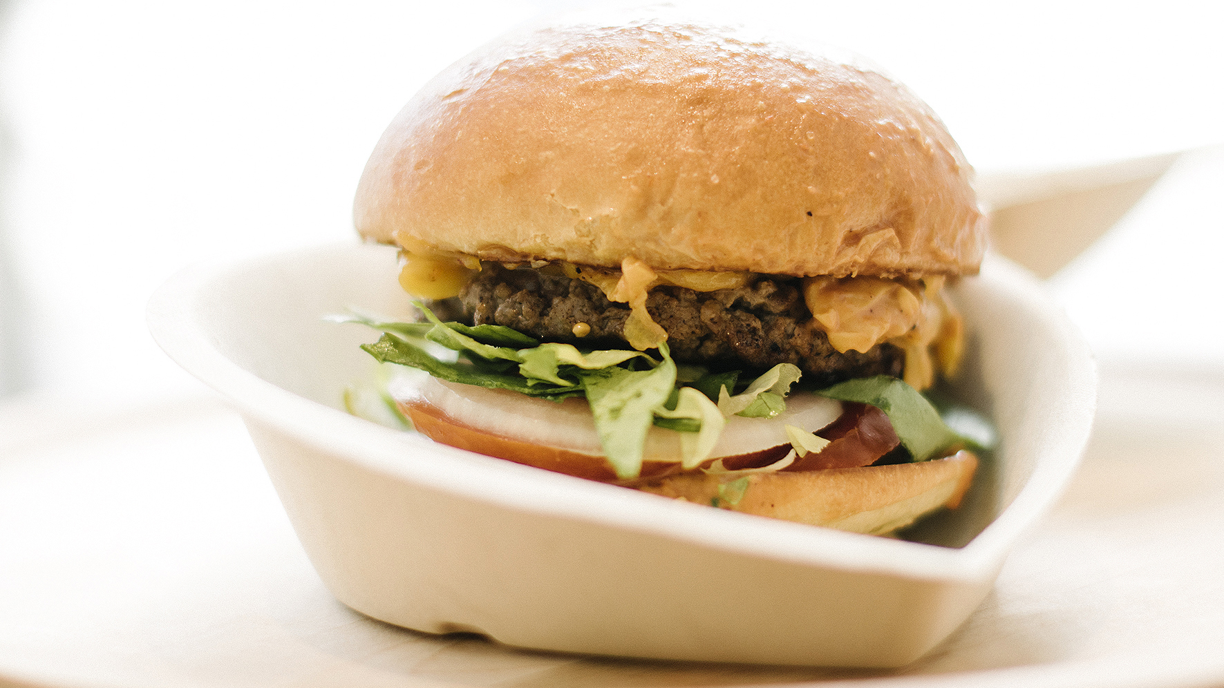 A Creator Burger fresh out of the robot that toasted the buns, sliced the produce, shredded the cheese, and cooked the beef.