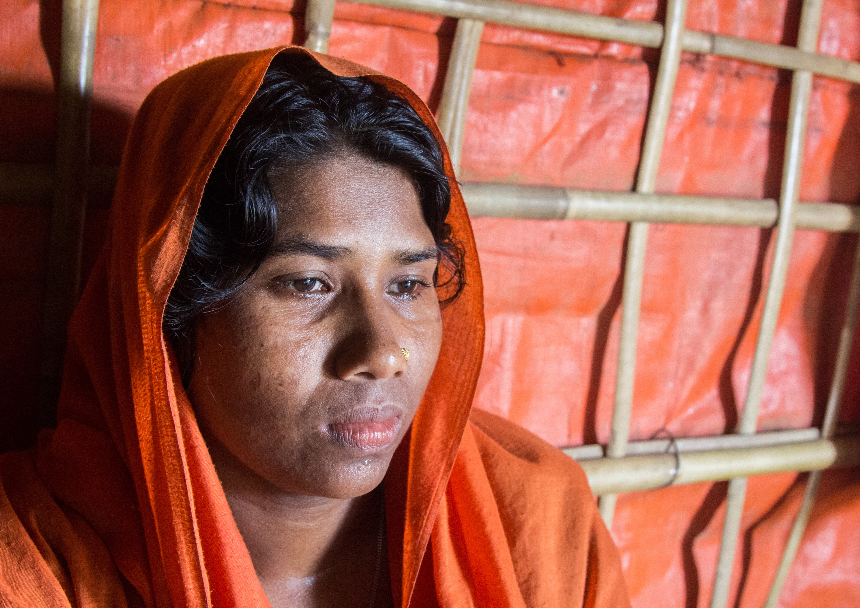 Dildar Begum, 30, in her shelter in the Hakimpara Rohingya refugee camp in Bangladesh. She says 29 members of her extended family were killed a year ago in what the U.S. has said was a campaign of ethnic cleansing by the Myanmar military. (Jason Beaubien/NPR)