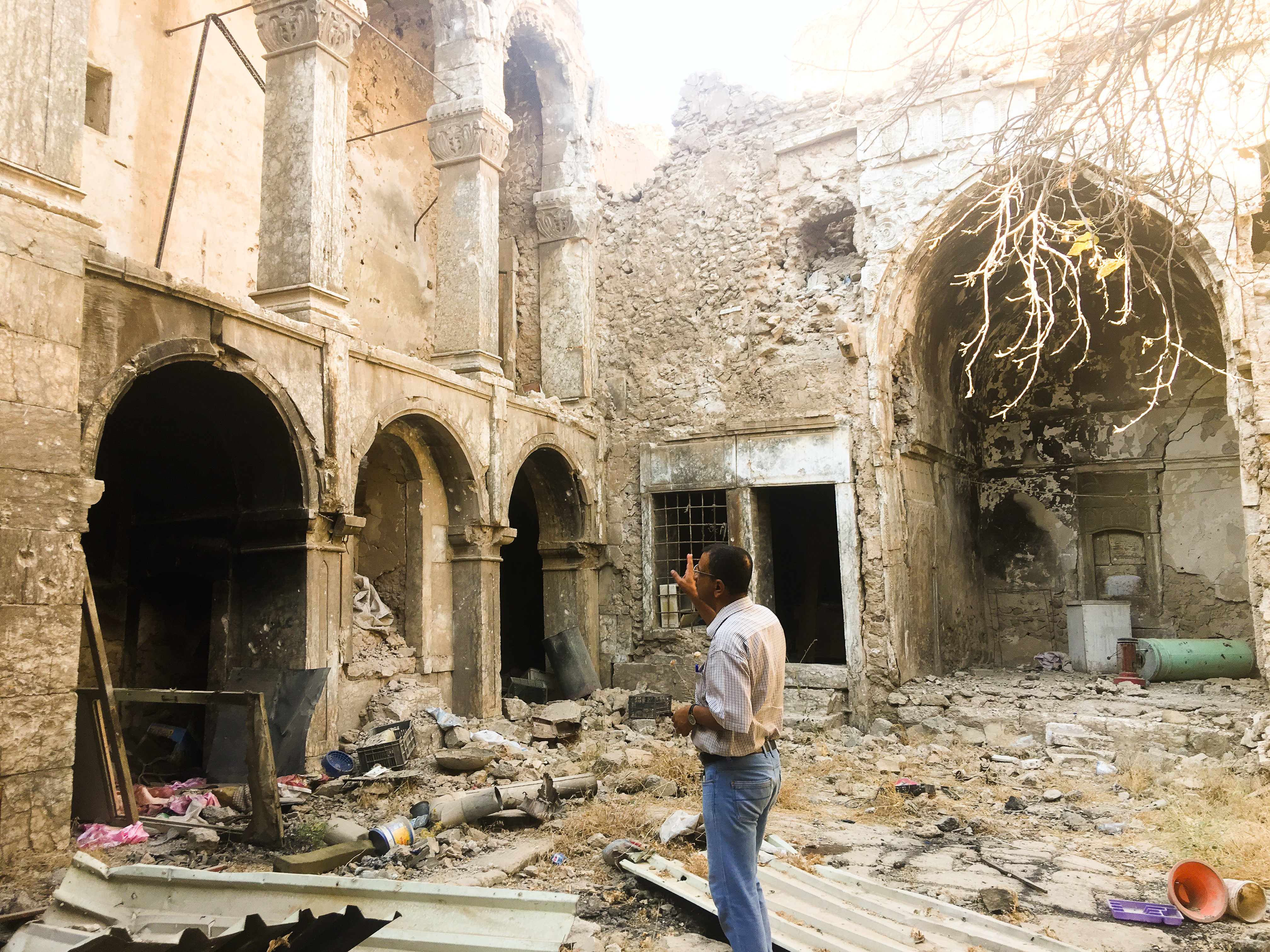 A Mosul resident looks at the ruins of a damaged historic house in his neighborhood in Mosul's Old City. The United Nations estimates 8,000 homes were damaged or destroyed in the fighting to take back this section of Iraq's second-biggest city. (NPR)