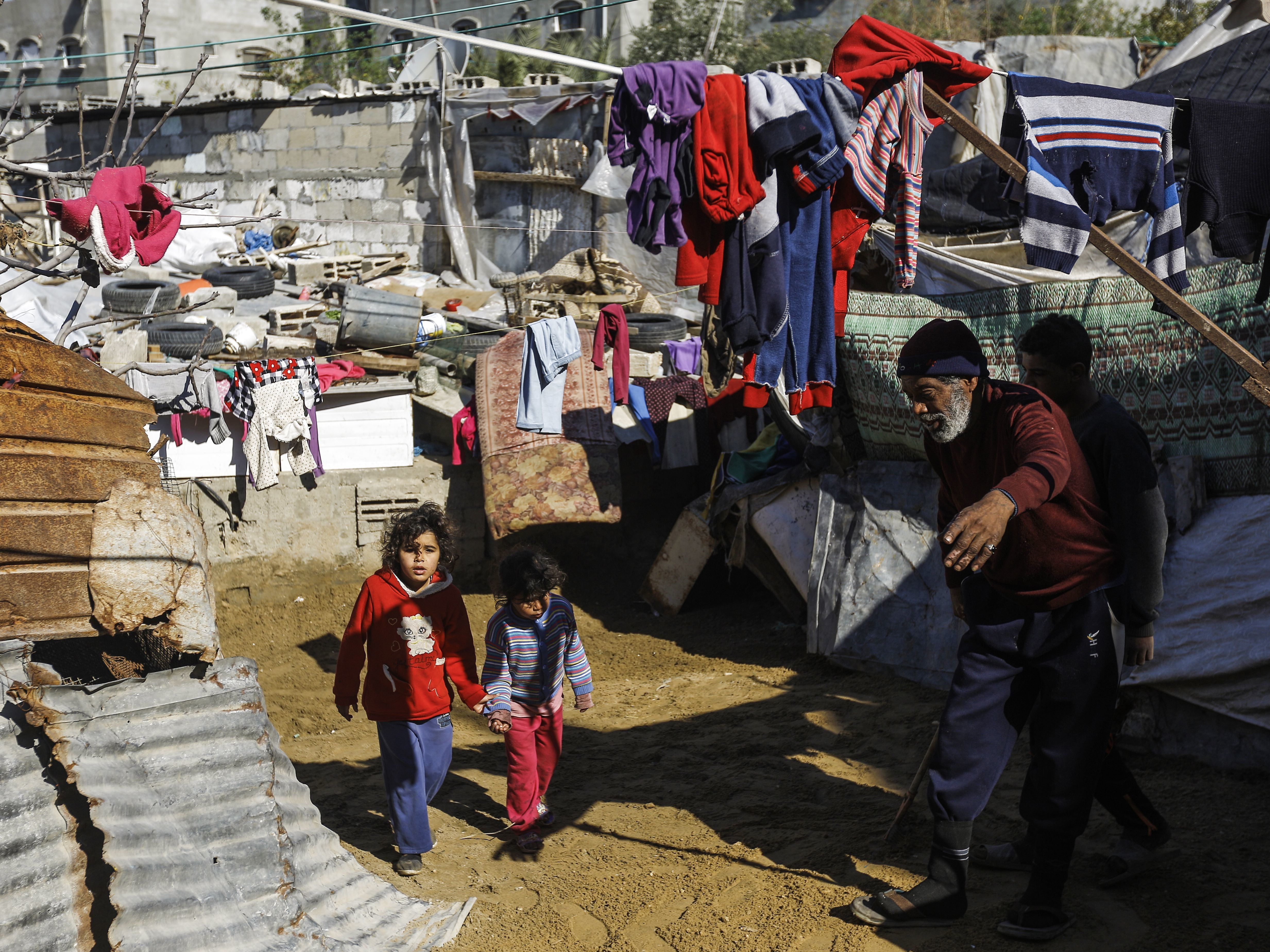 Two Palestinian girls walk in the Jabalia refugee camp in the northern Gaza Strip in 2017. (AFP/Getty Images)
