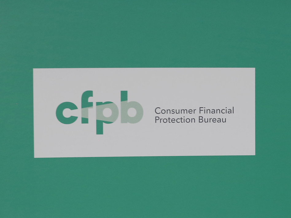 President Obama visits the Consumer Financial Protection Bureau in 2014. (Larry Downing/Reuters)