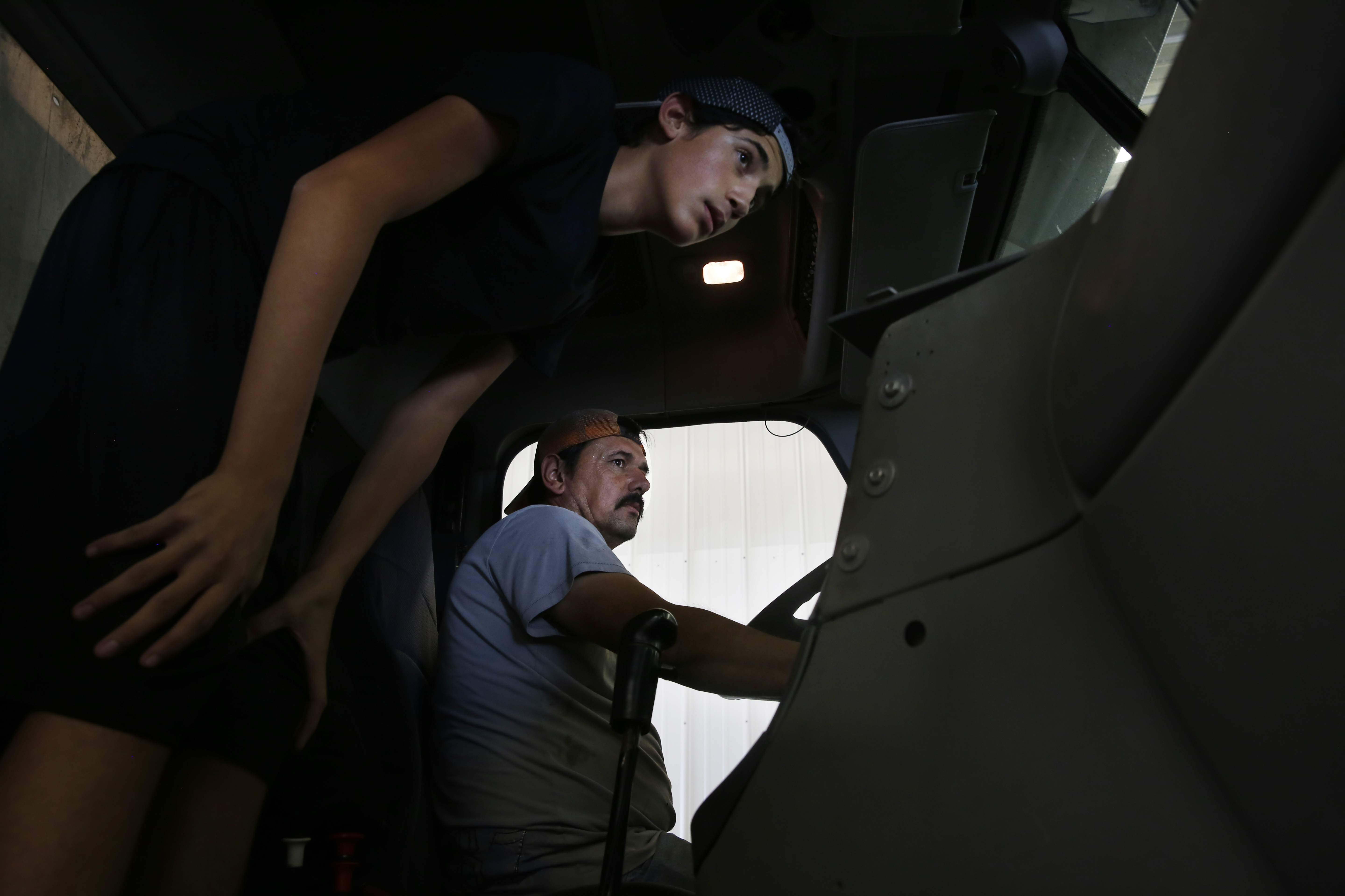 In One Generation, A Farmworker Family Grows College Ambitions 14 Angel visits his father, Juan, at work as he prepares machinery for the corn harvest.