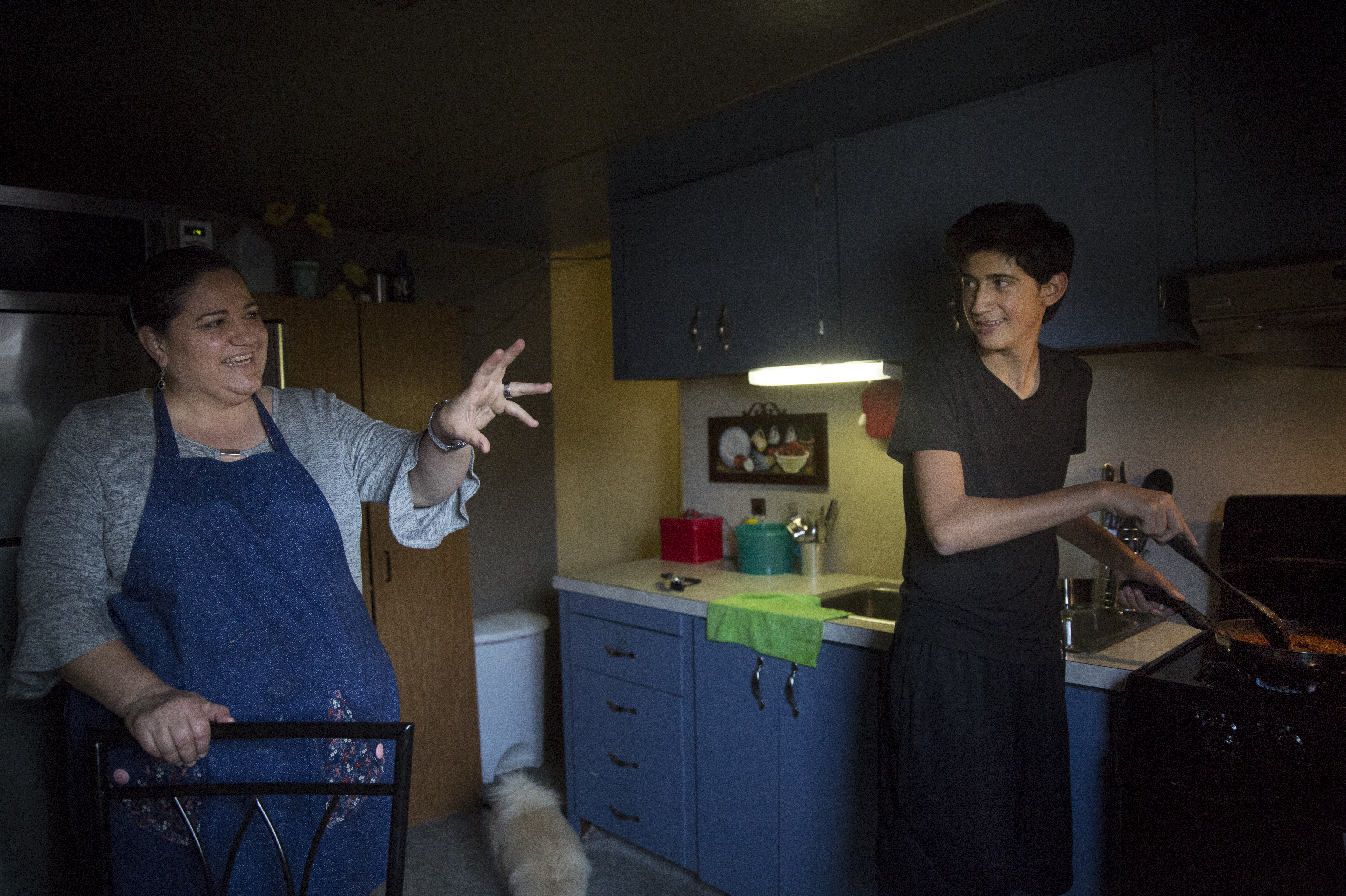 In One Generation, A Farmworker Family Grows College Ambitions 12 Angel and his mom, Aracely, cook dinner after school.