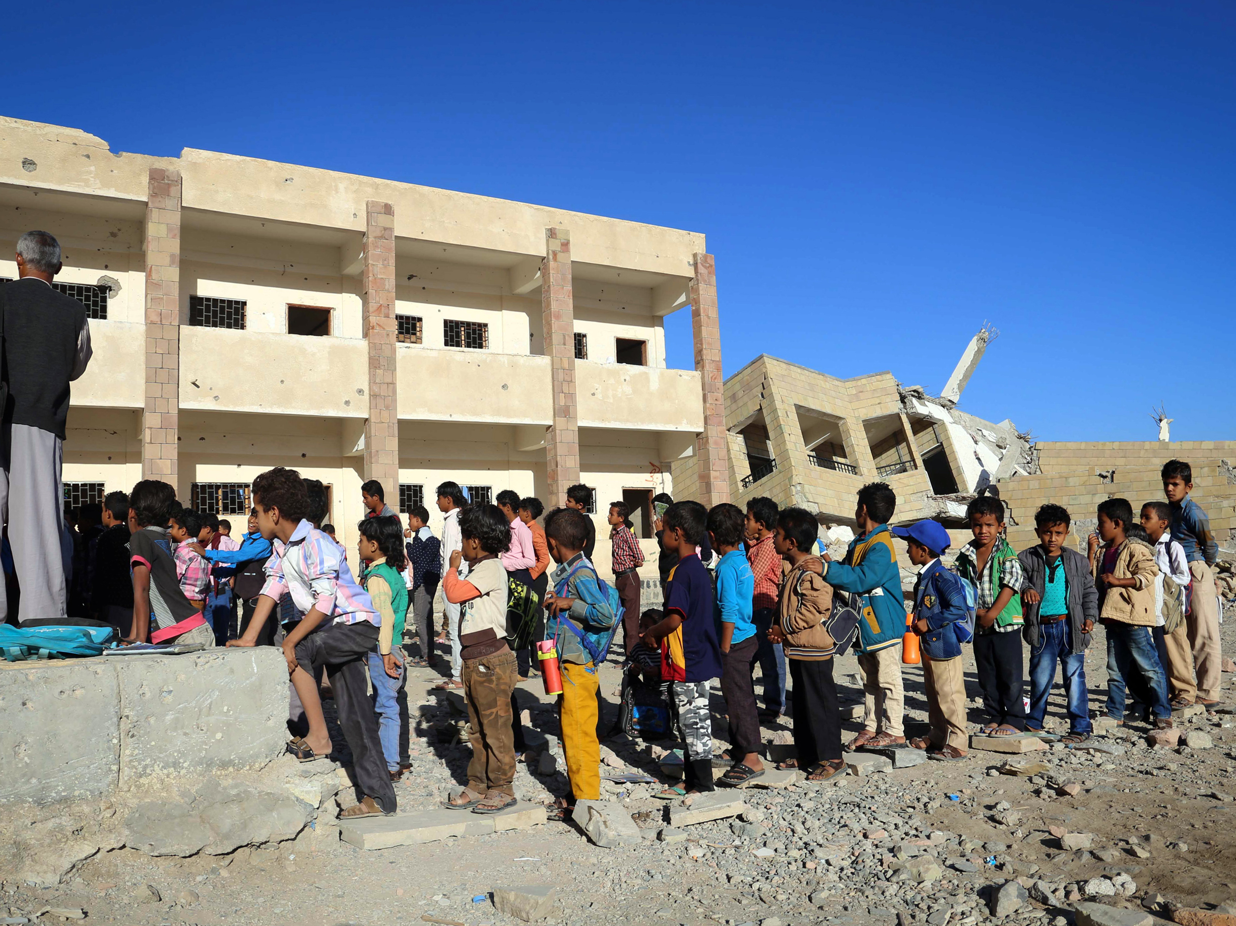 Yemeni children gather outside their classroom in  Dec. 2016, at a school that was recently damaged in a Saudi-led air strike in the country's third-city of Taez. (AFP/Getty Images)
