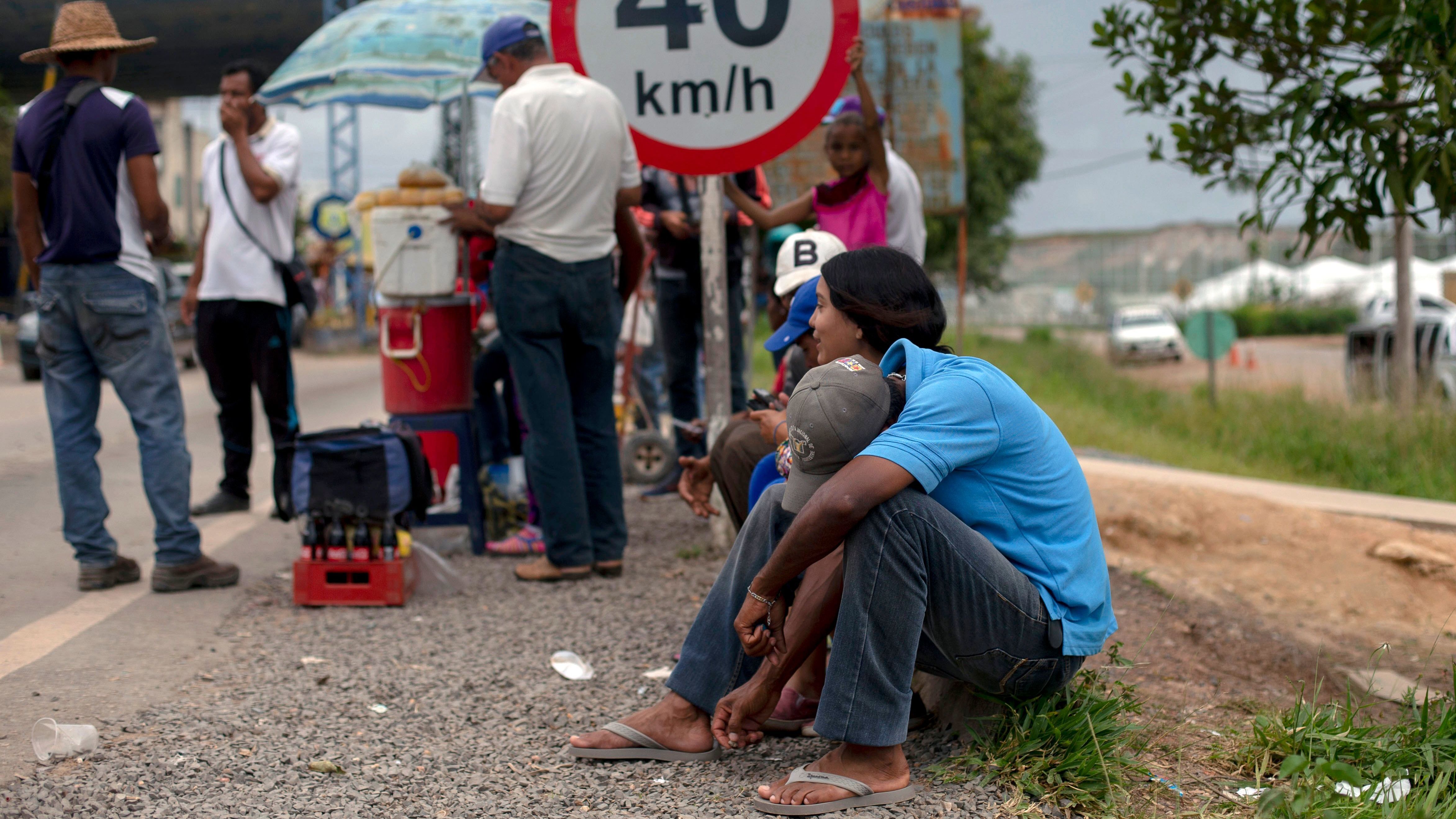 Venezuelan refugees wait outside the Brazilian Immigration Point in the border city of Pacaraima, Roraima, Brazil, on Aug. 20. Brazil's president said armed forces would be sent to the area. (AFP/Getty Images)