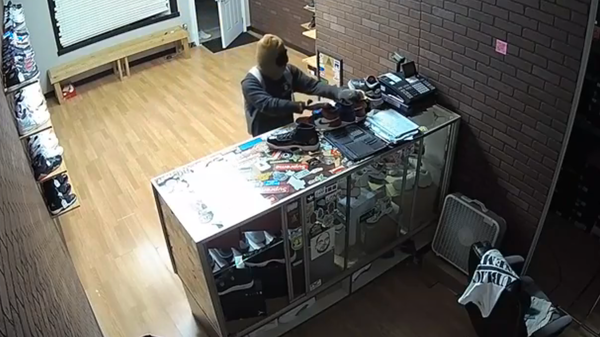 A burglar, shown in a video released by the Roanoke County Police Department, stole a selection of shoes at Clean Soles.