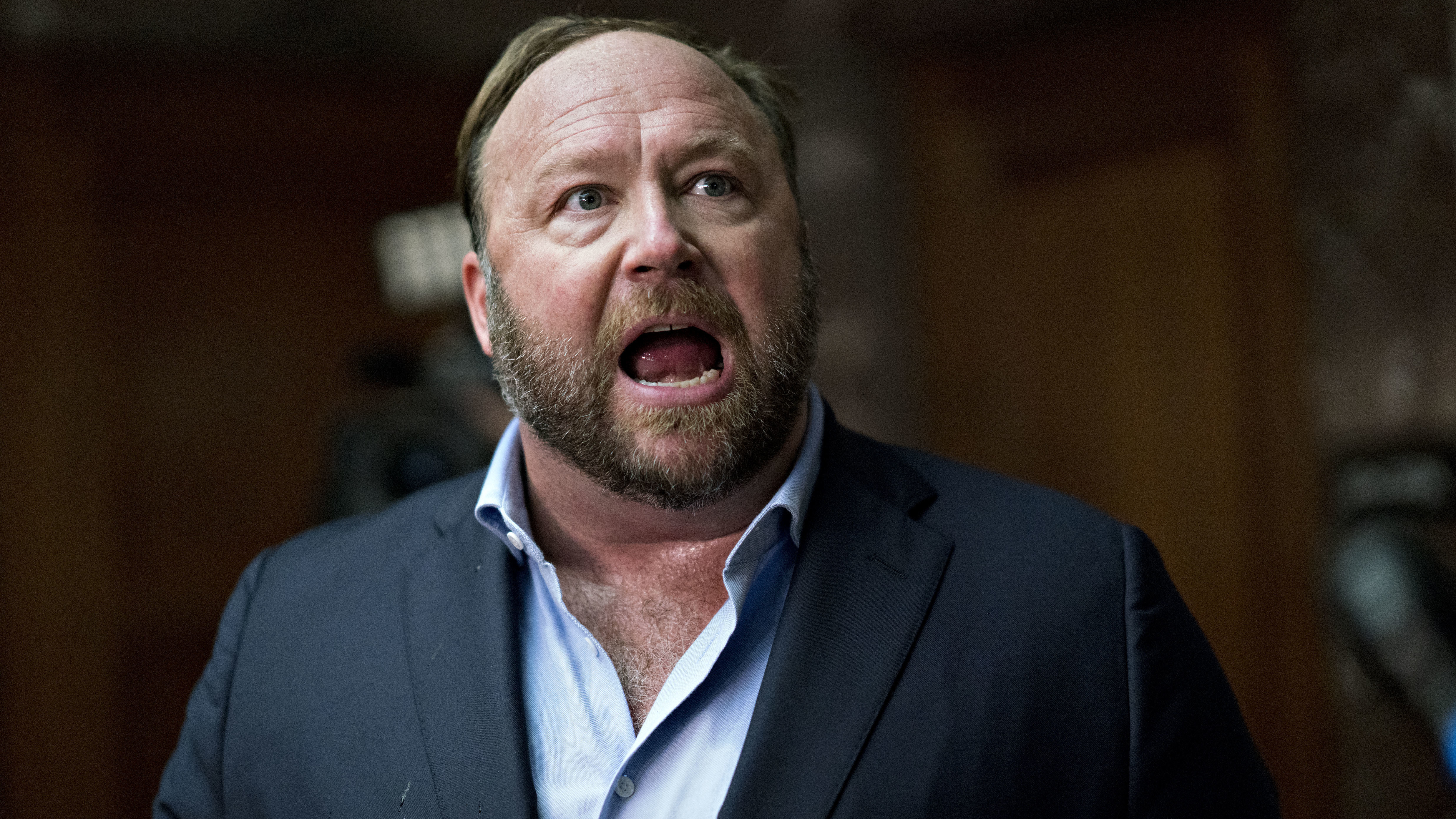 Alex Jones, radio host, conspiracy theorist, and creator of the website InfoWars, speaks to members of the media outside a Senate Intelligence Committee hearing on Wednesday.
