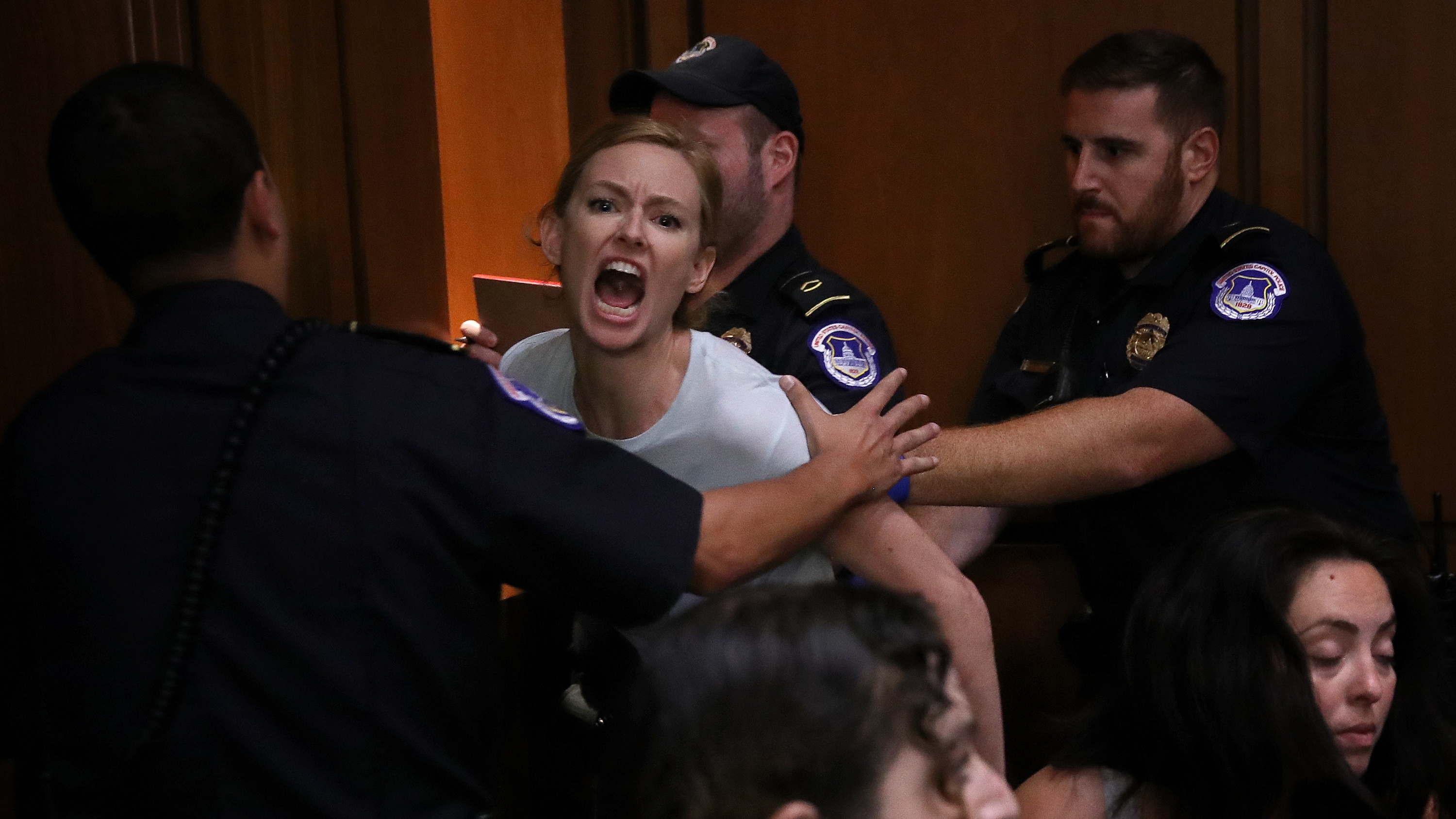 A protester is led away by police after disrupting the second day of the confirmation hearing for Supreme Court nominee Judge Brett Kavanaugh on Capitol Hill. (Getty Images)