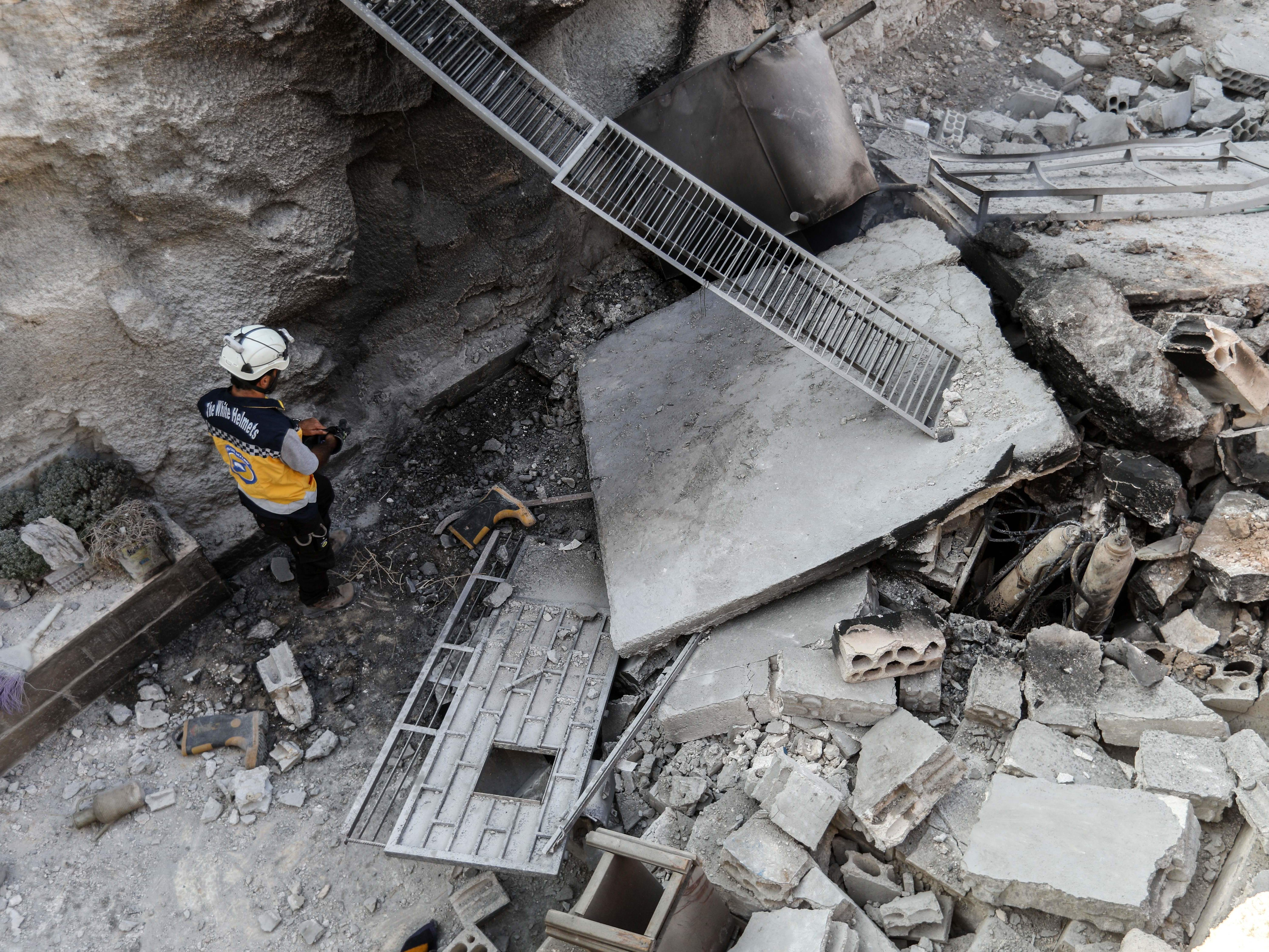 A member of the Syrian Civil Defense, also known as the "White Helmets," walking through the wreckage of their center, which was destroyed Thursday by government forces in the town of al-Tamana in rebel-held Idlib province.