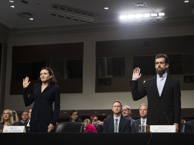 Facebook Chief Operating Officer Sheryl Sandberg and Twitter Chief Executive Officer Jack Dorsey testify during a Senate intelligence committee hearing on Sept. 5. (Drew Angerer/Getty Images)