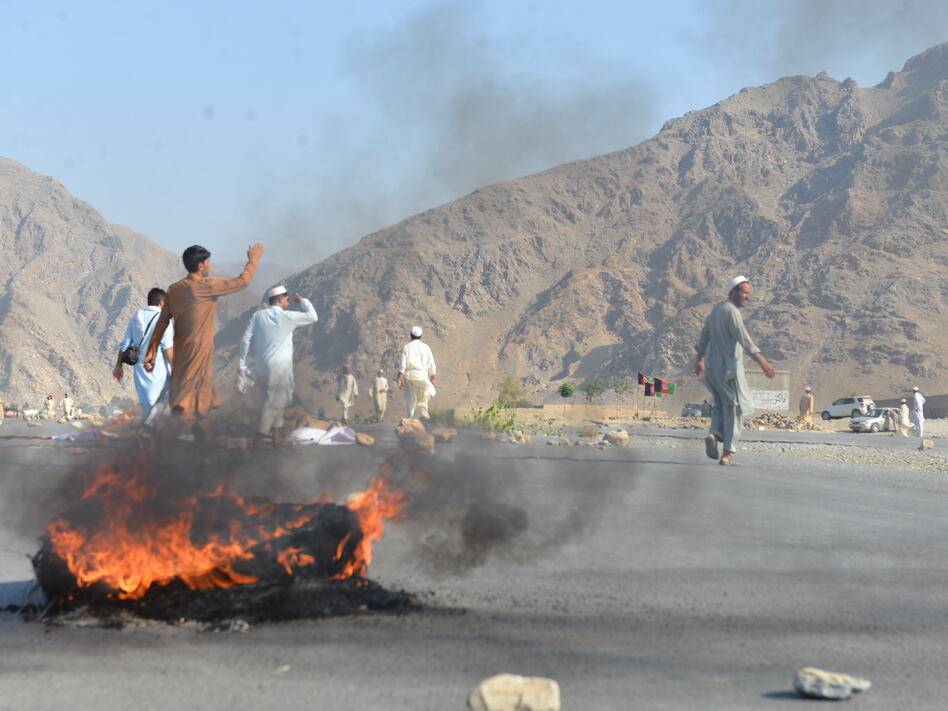 Men shout slogans against terrorists after a suicide attack among the protesters in Momandara district of Nangarhar province, Afghanistan, on Tuesday.