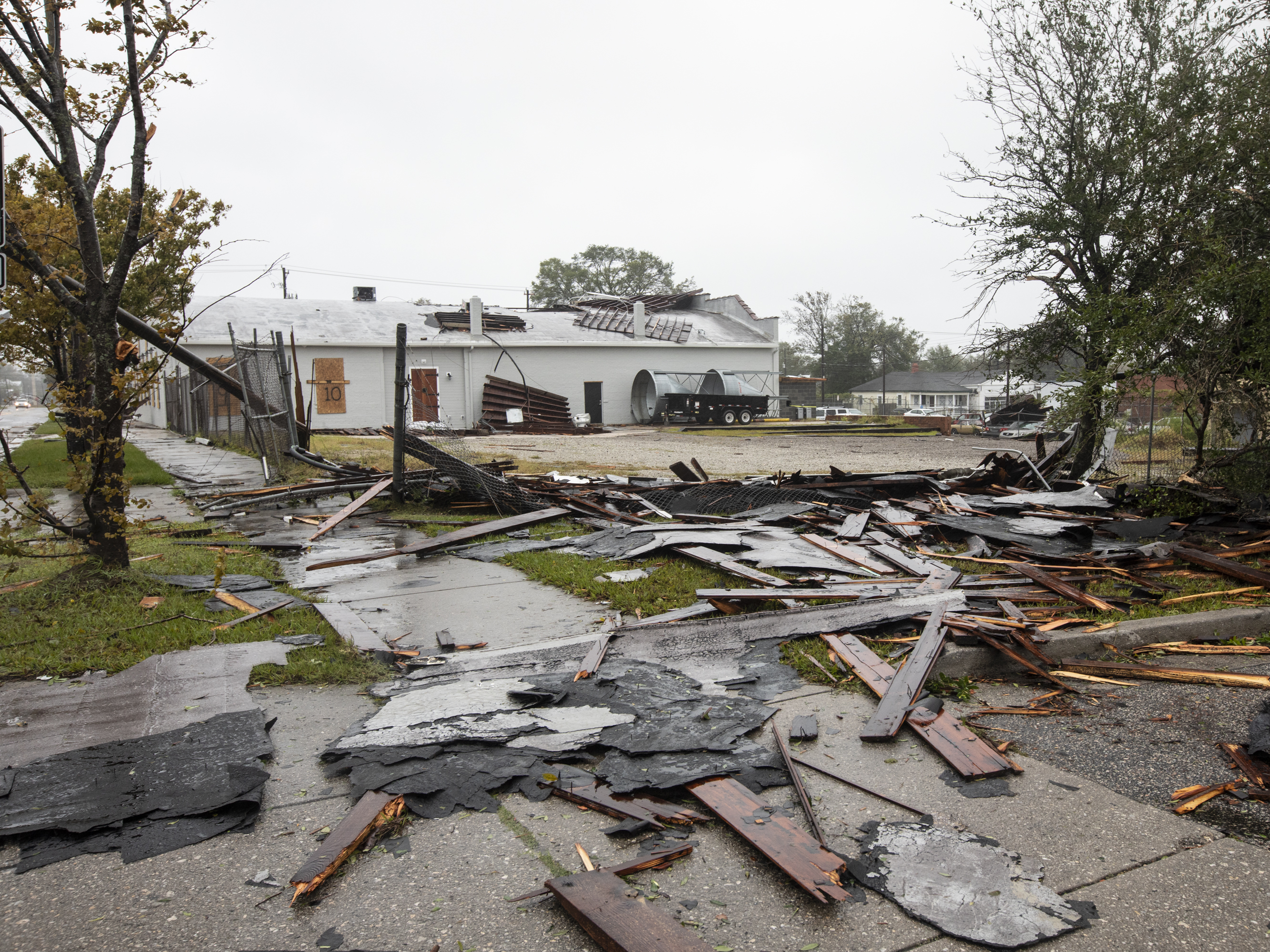 Debris from a nearby rooftop shows the force of Tropical Storm Florence's wind gusts in Wilmington, N.C., on Friday. (Phyllis B. Dooney for NPR)