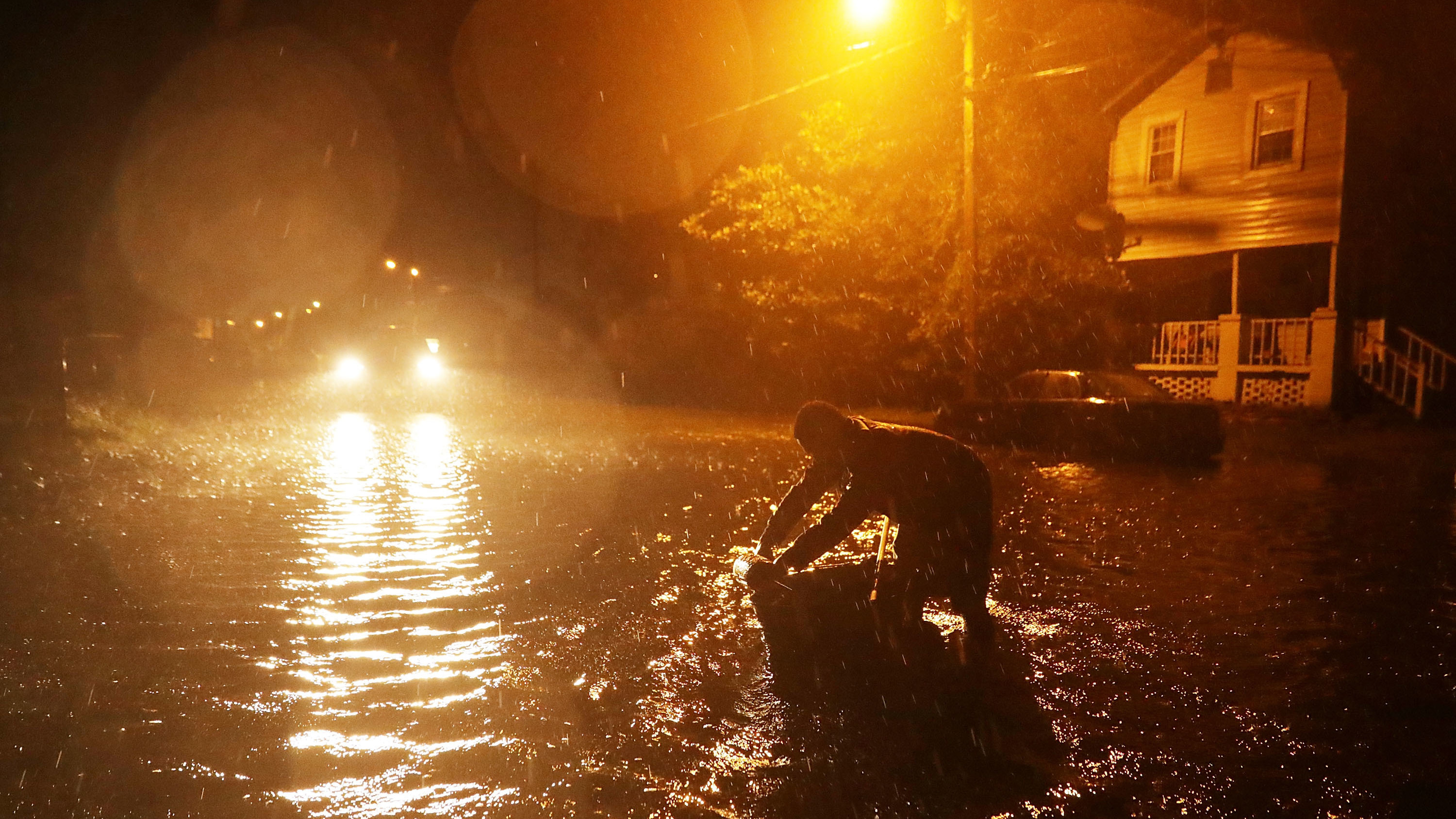 Michael Nelson floats in a boat made from a metal tub and fishing floats after the Neuse River went over its banks and started to flood his street in New Bern, N.C., on Thursday. (Getty Images)