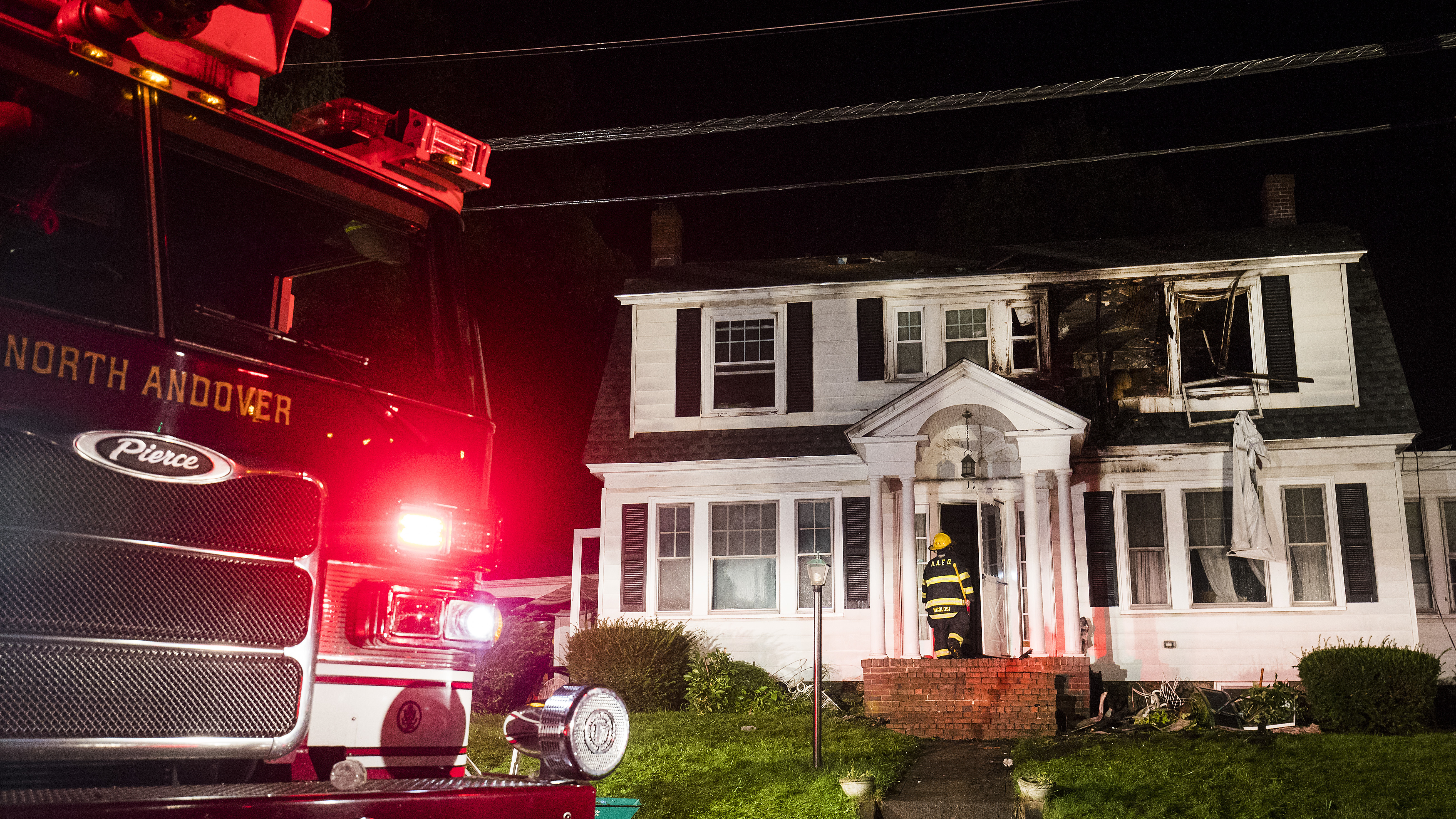 Firefighters inspect a home after gas explosions on Thursday in North Andover, Mass. Gas explosions in three communities north of Boston left multiple homes on fire. (Getty Images)
