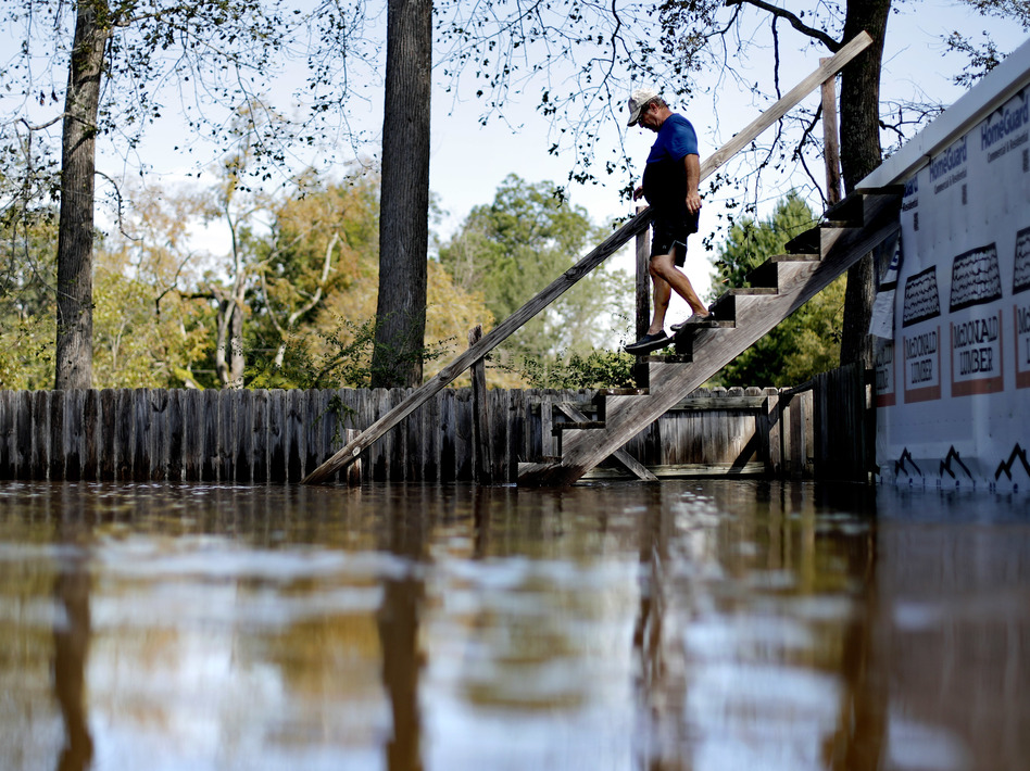 Kenny Babb walks down a staircase on his flooded property as the Little River continues to rise in the aftermath of Hurricane Florence. Coastal residents may have to accept floods as part of life. (David Goldman/AP)